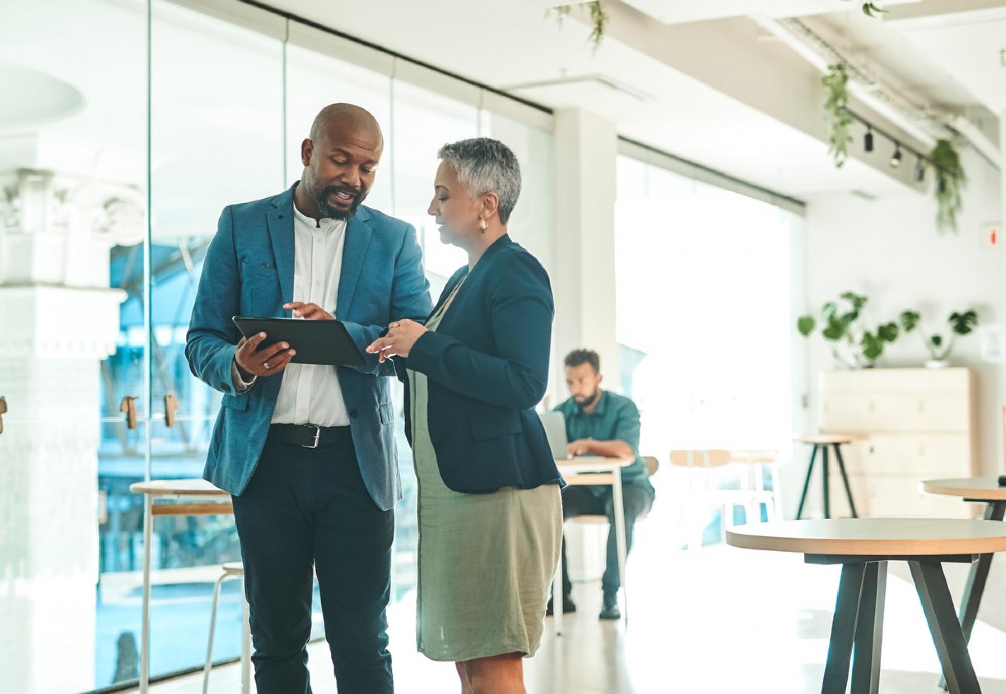 Business people talking around a tablet