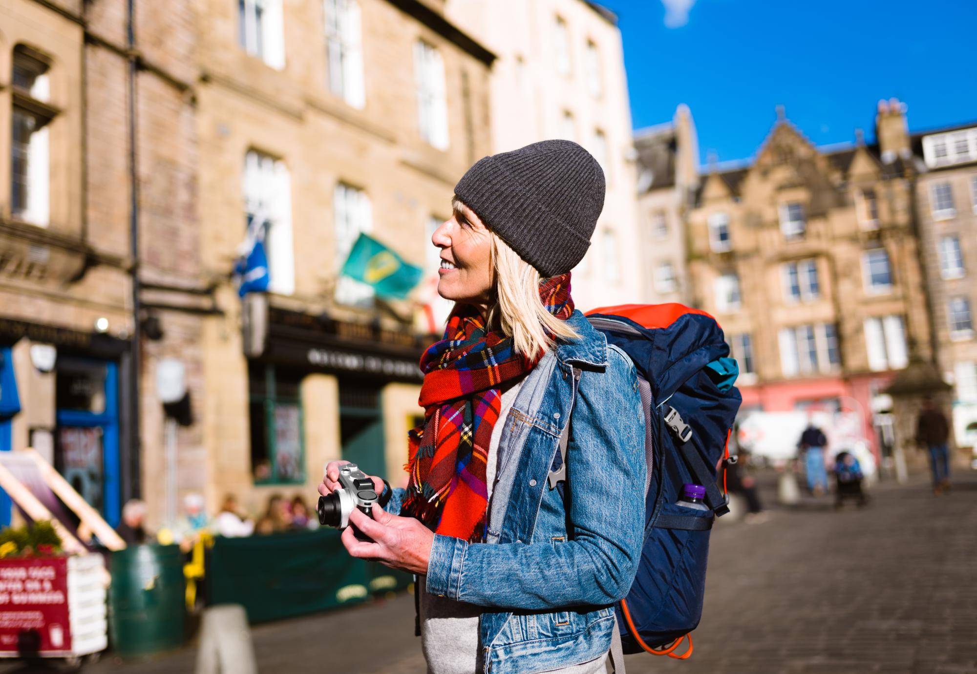 Tourist photographing at the Grassmarket, Edinburgh, Scotland.