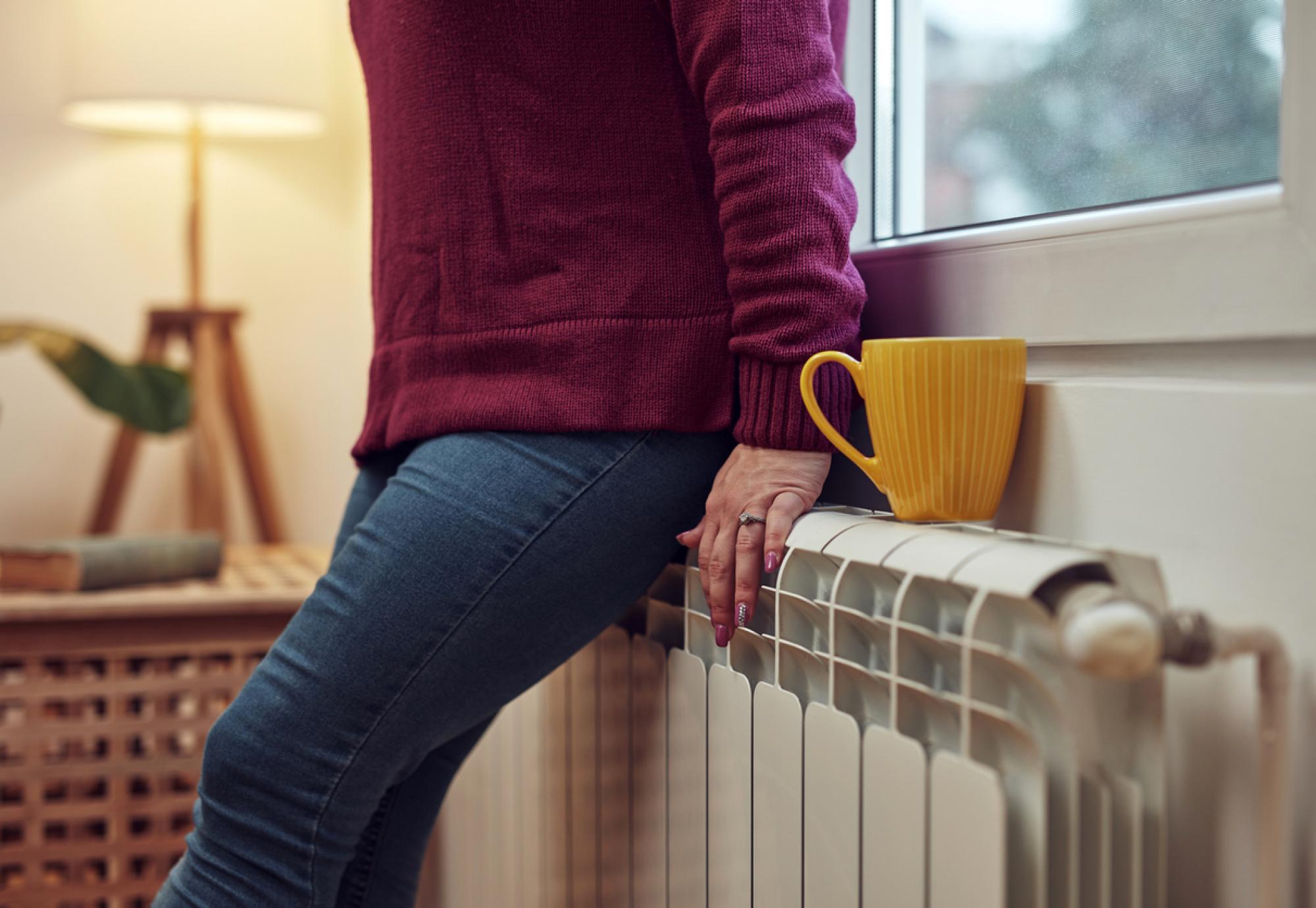 Woman heating on a chilly winter day