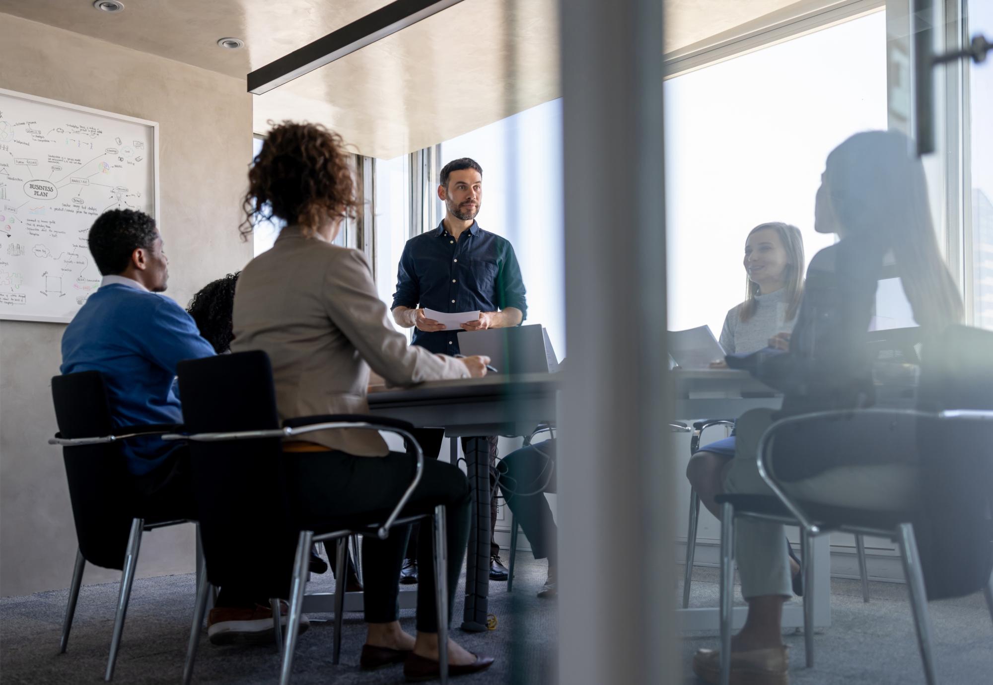 man talking to his team in a meeting at the office