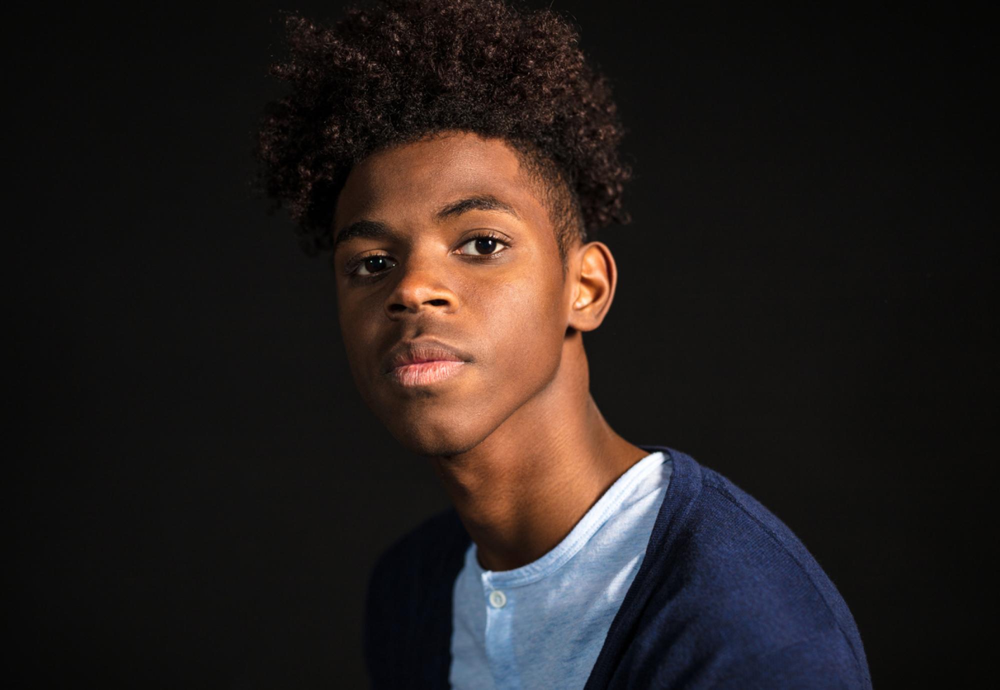 Close-up portrait of confident young man in casuals looking at camera