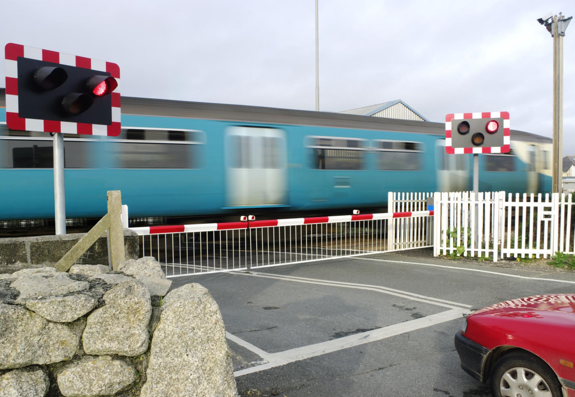 Motion Blurred Train At Level Crossing Cornwall UK