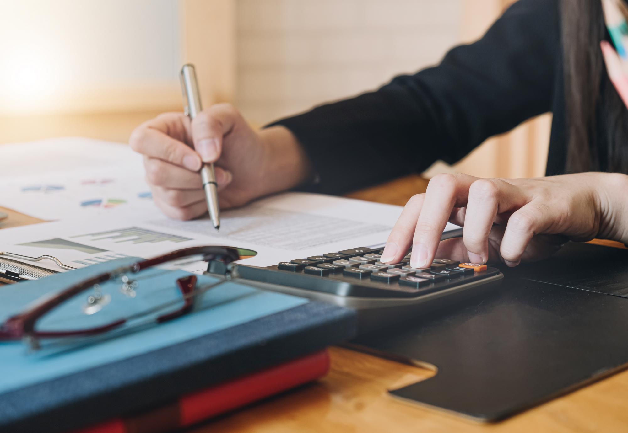 Accountant working with calculator for investigation