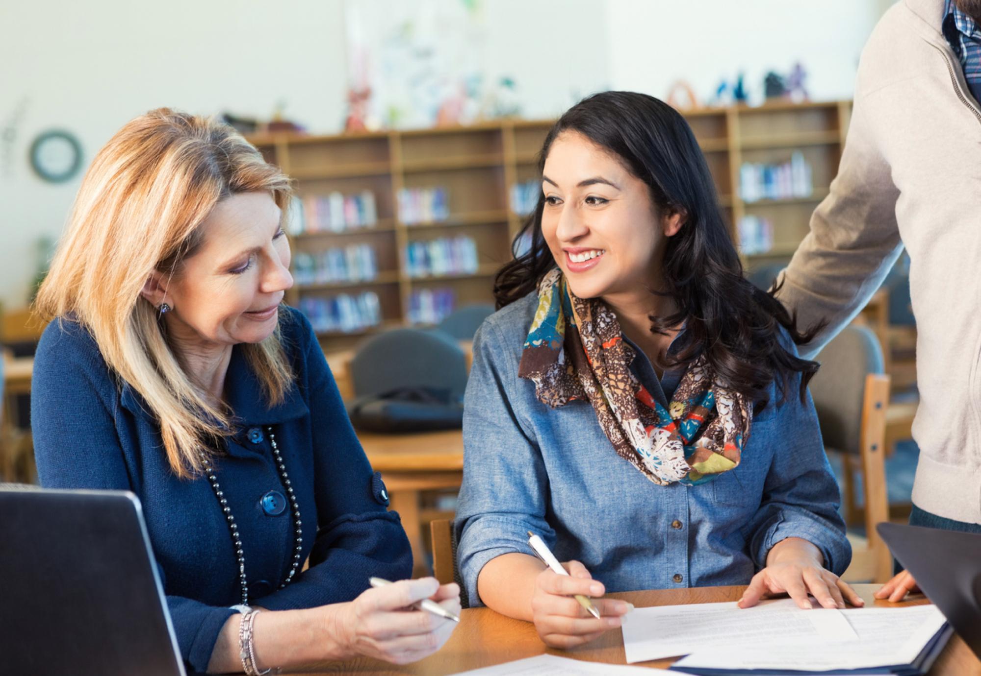 Adult college student talking to professor