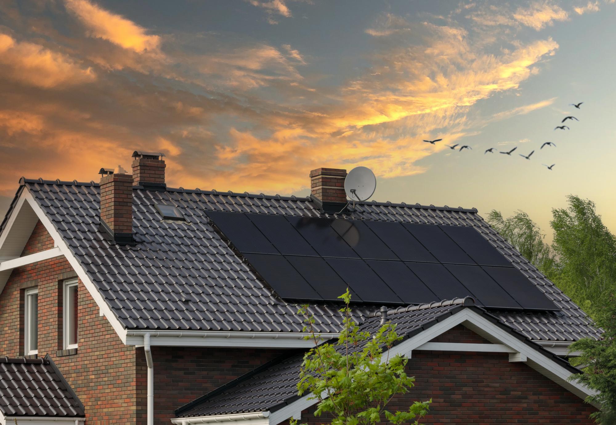 Brick house, solar panels, beautiful sunset.