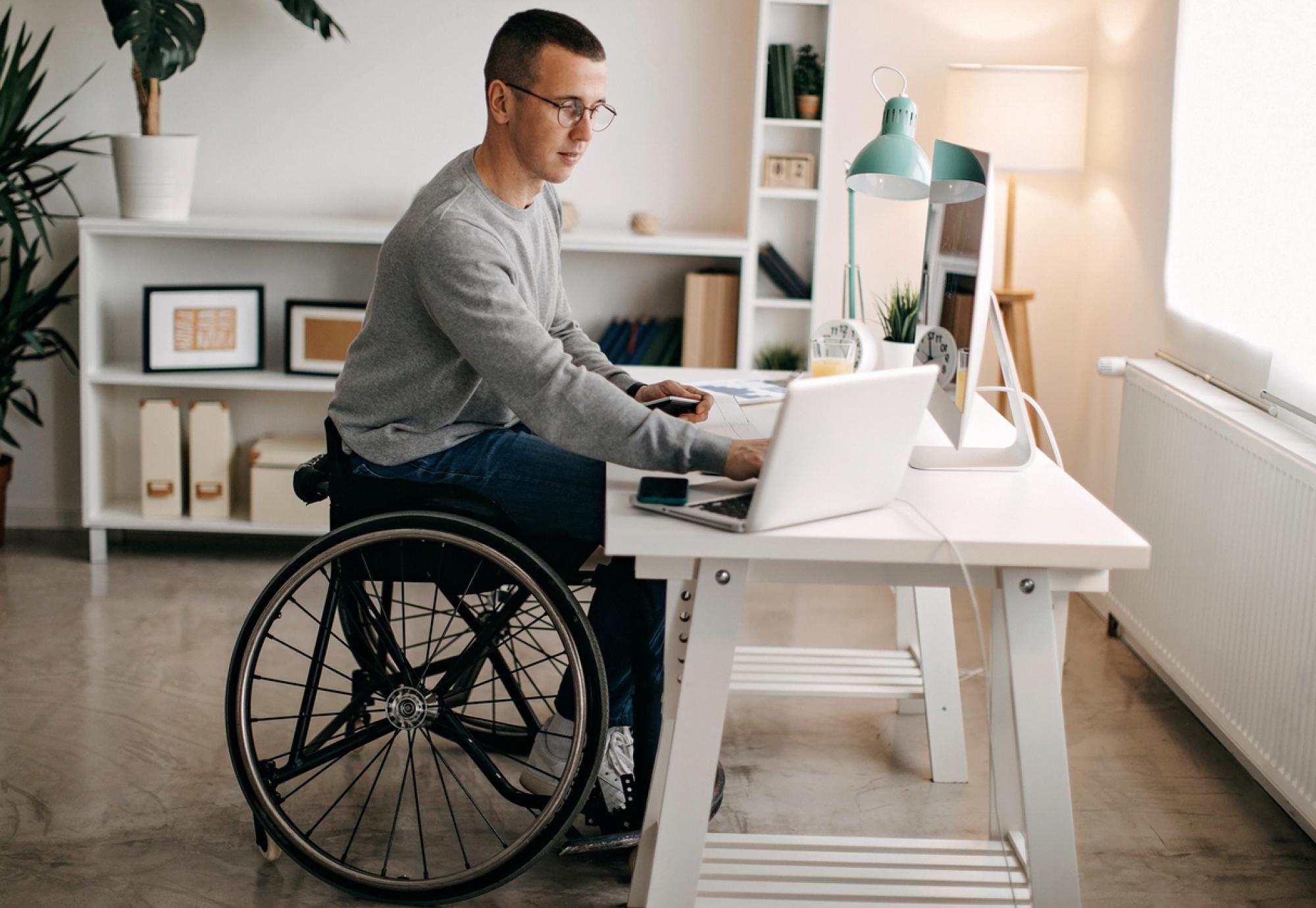 Young man with disabilities working on computer