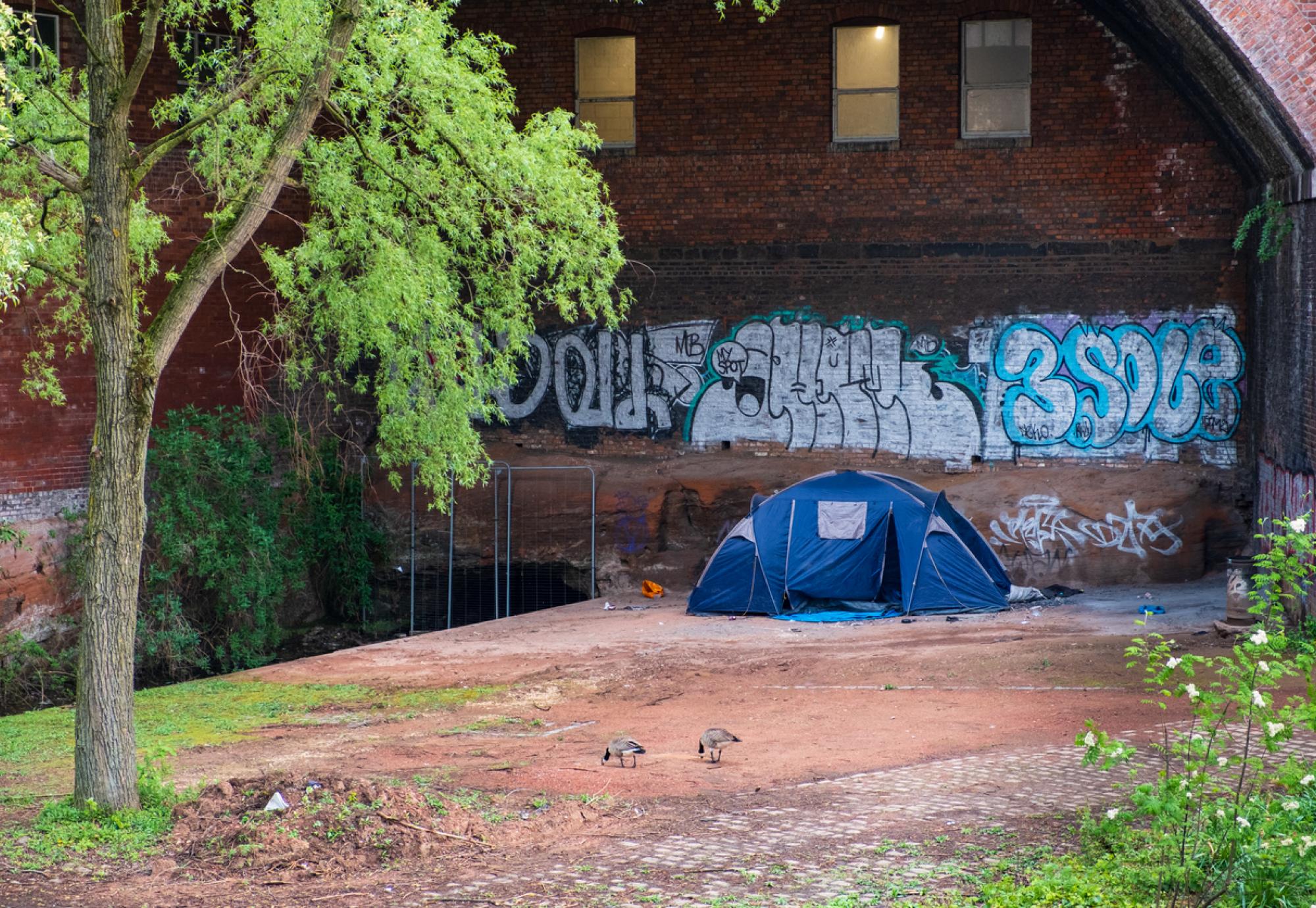 a tent hosting homeless people by the canal in Castlefield, Manchester