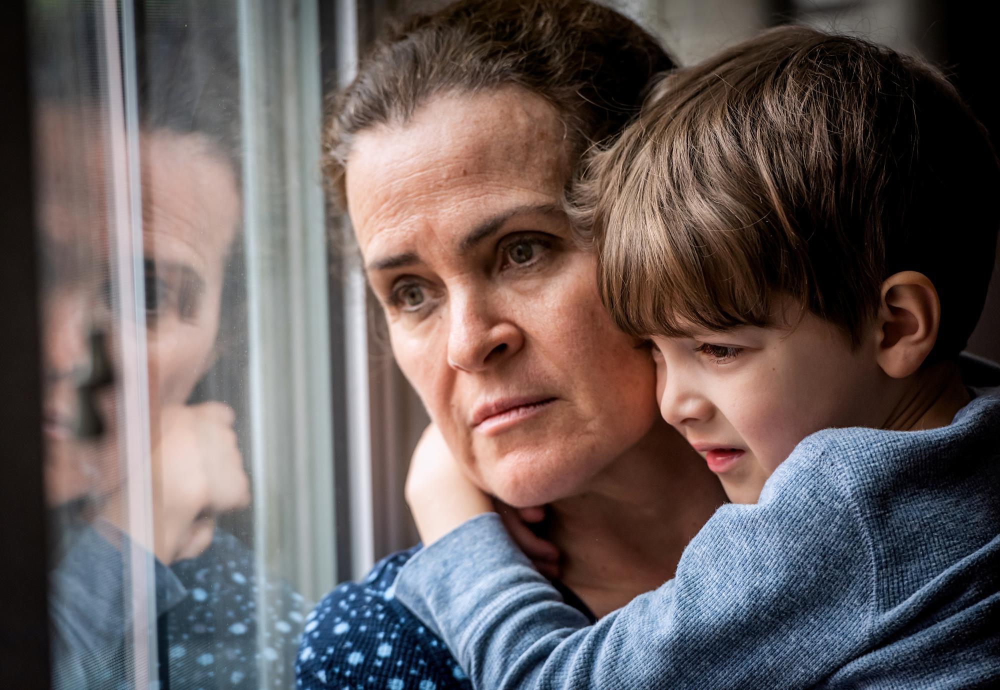 Pensive Mature woman posing with her son