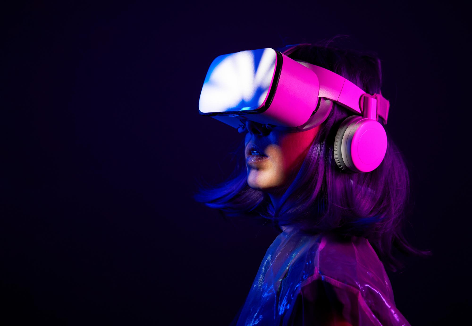 Woman in virtual reality goggle in neon colors
