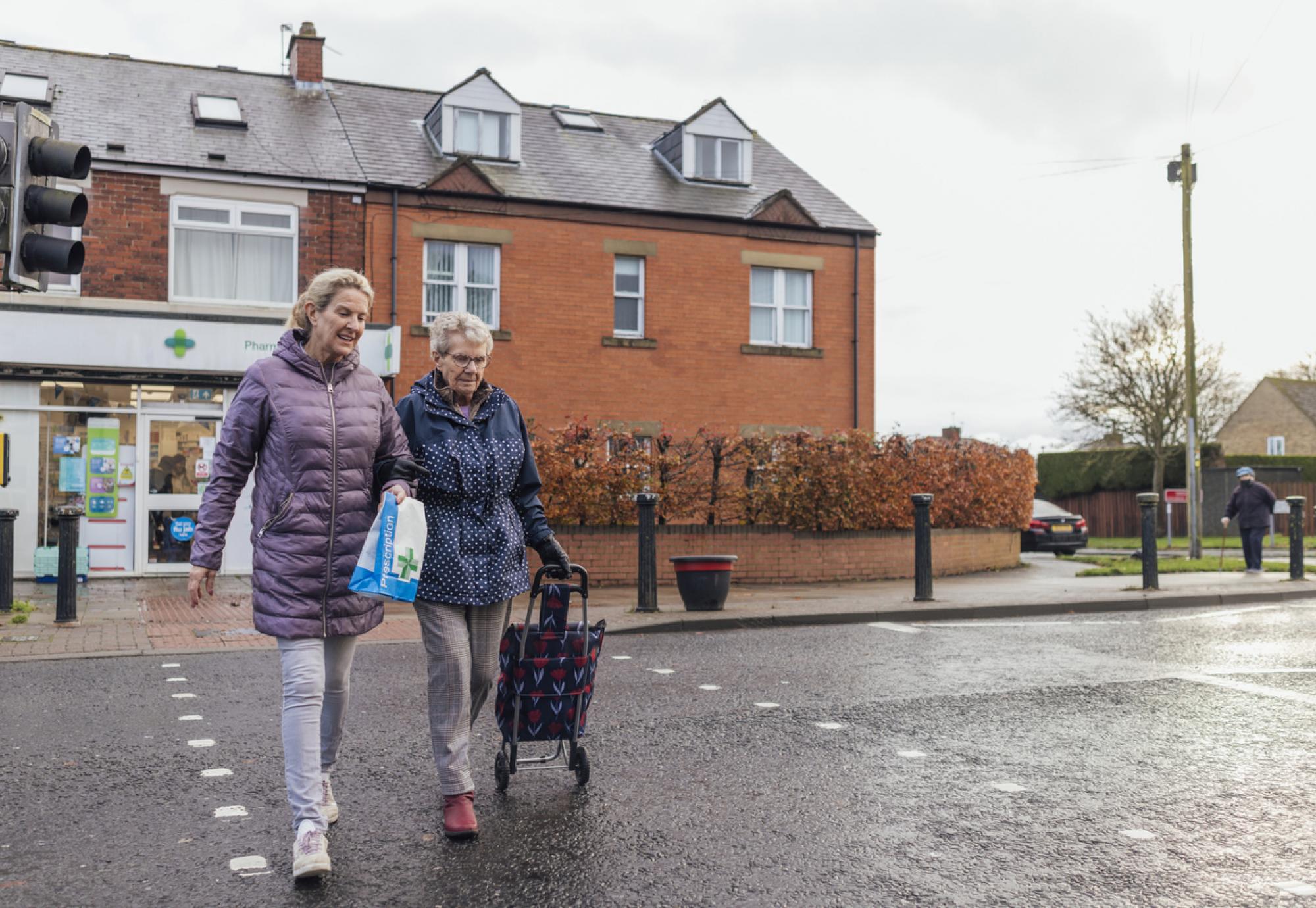 An elderly woman out with her unpaid carer