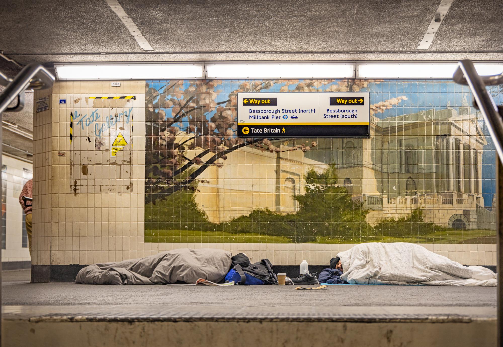 Homeless people sleeping in a London tube station