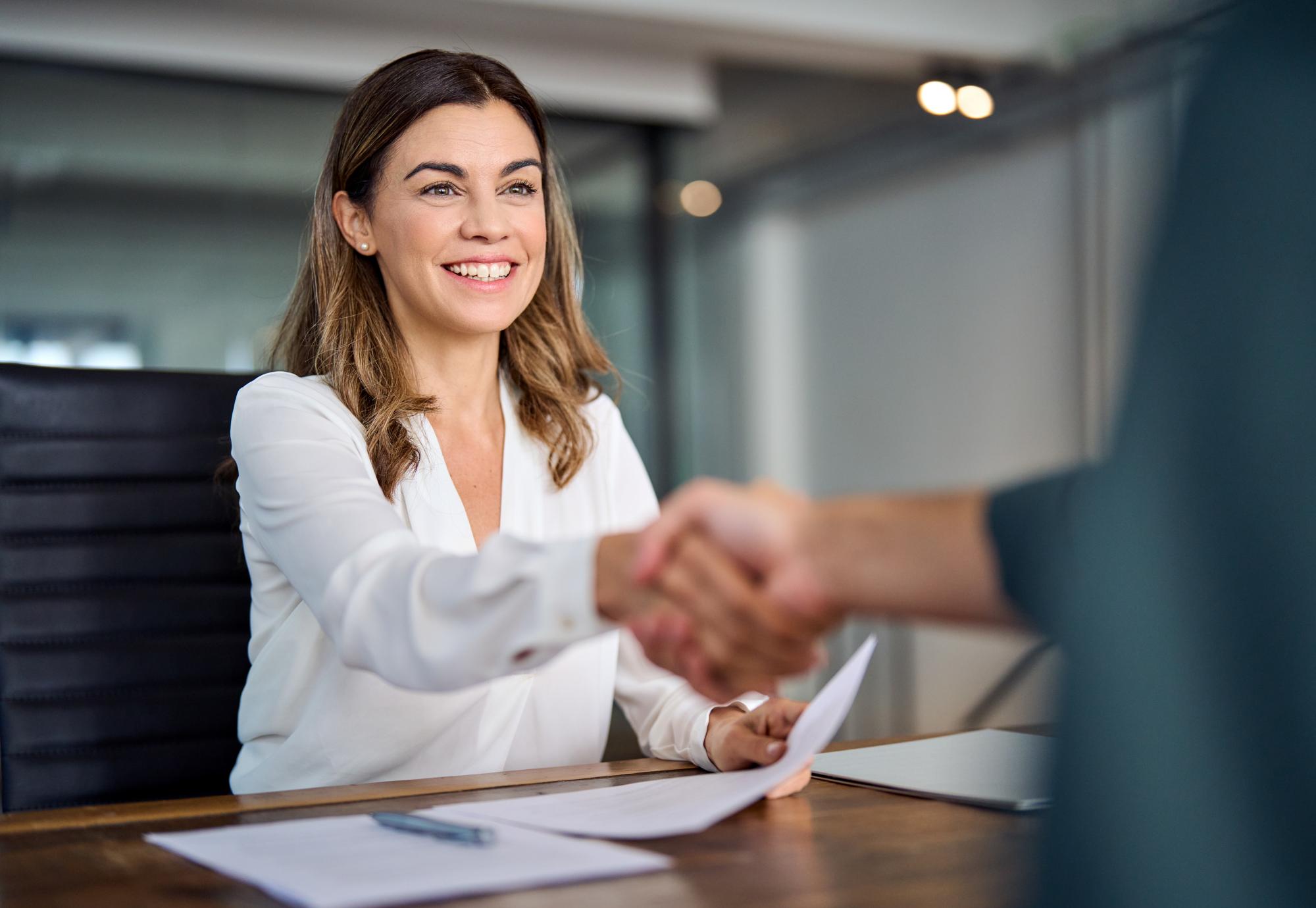 Public sector worker smiling and shaking hands