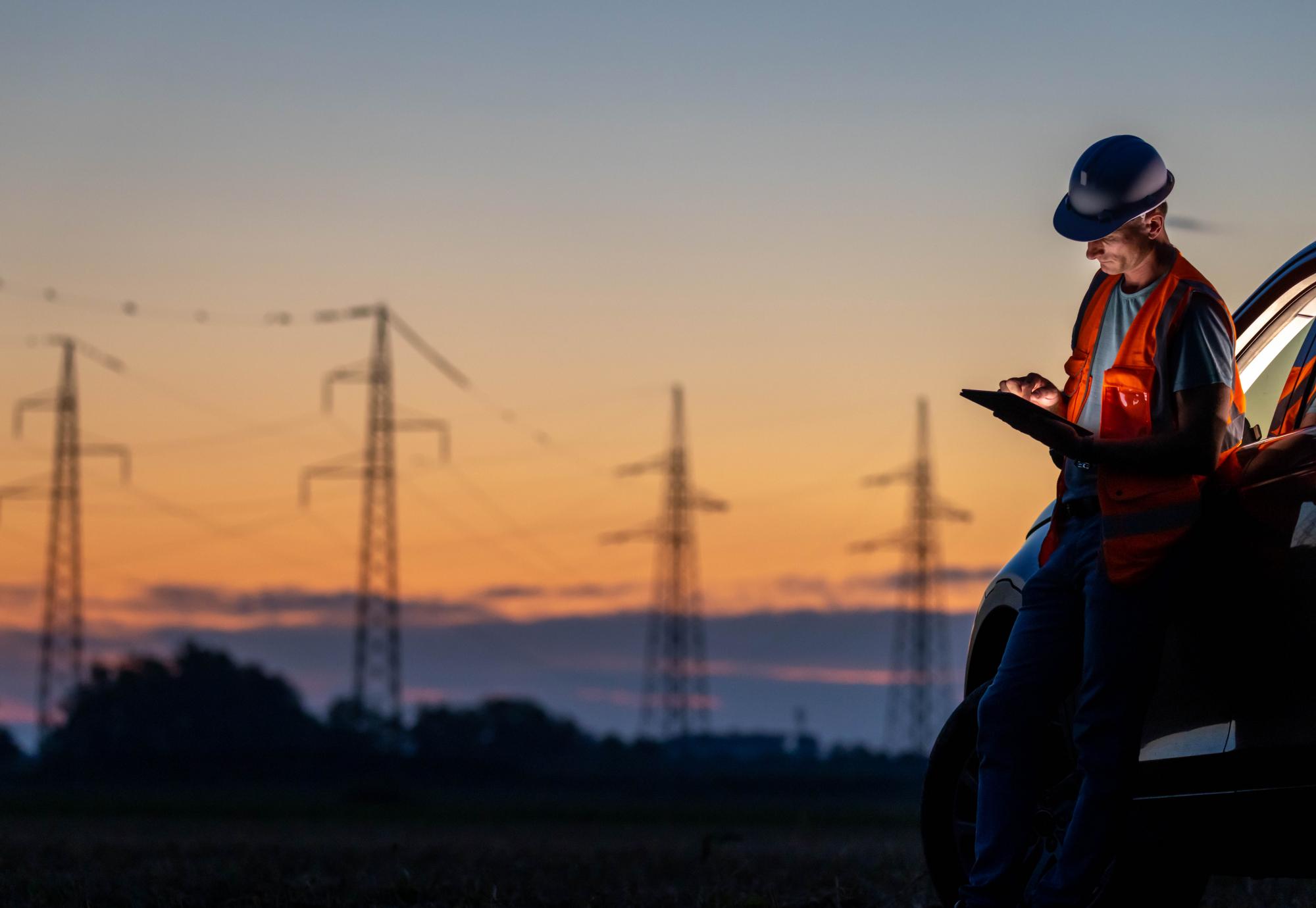 An Engineer working near high voltage poles