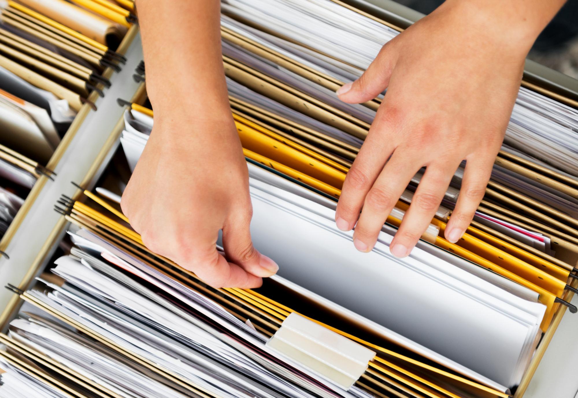 Hands searching through files