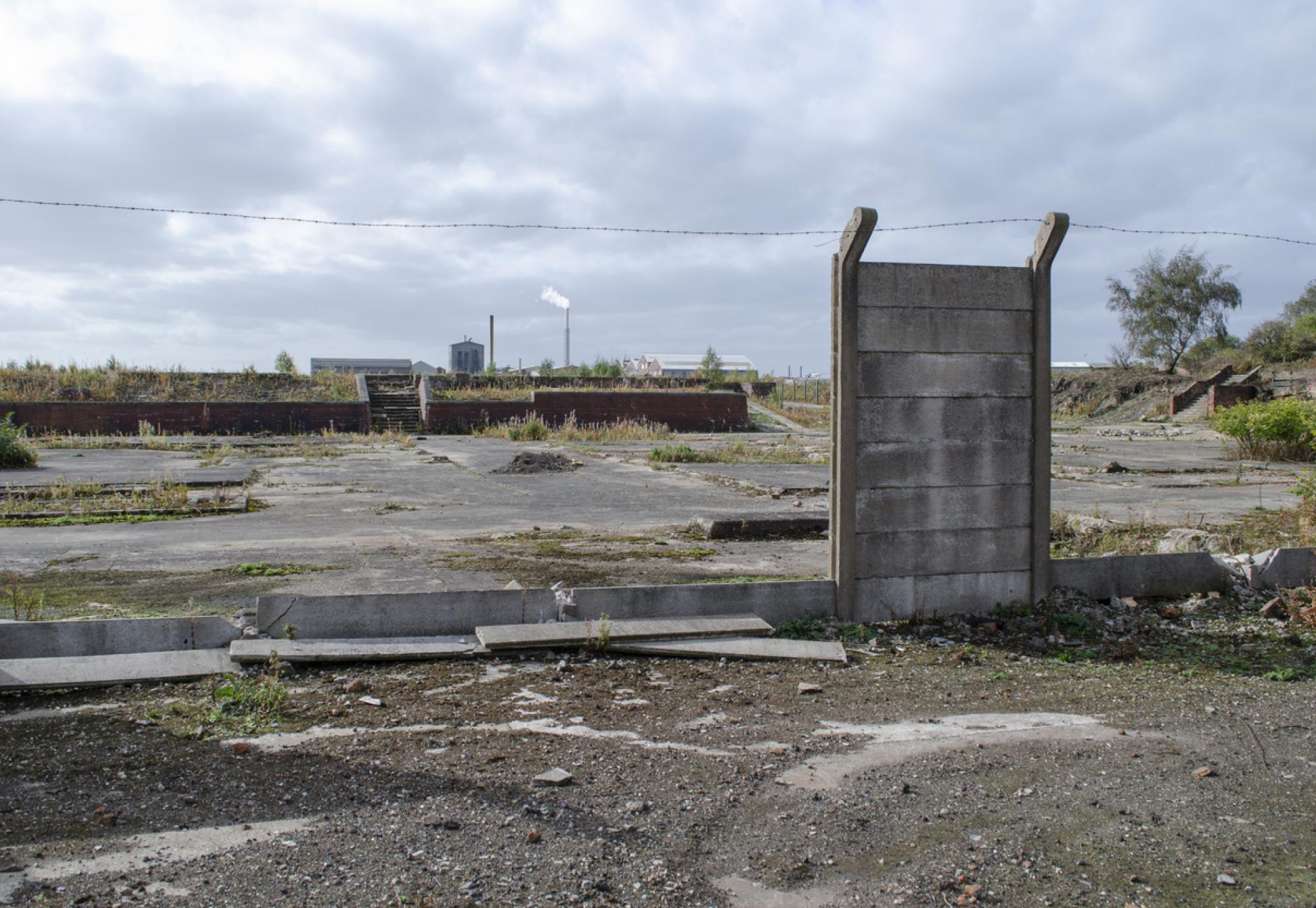 Brownfield land site with derelict wall