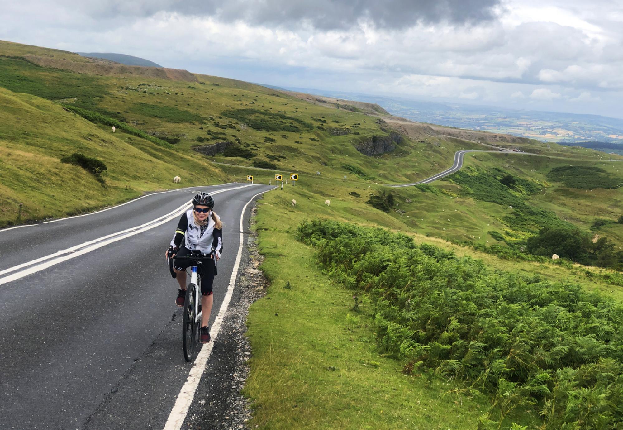 Female cyclist riding in Brecon Beacons, Wales