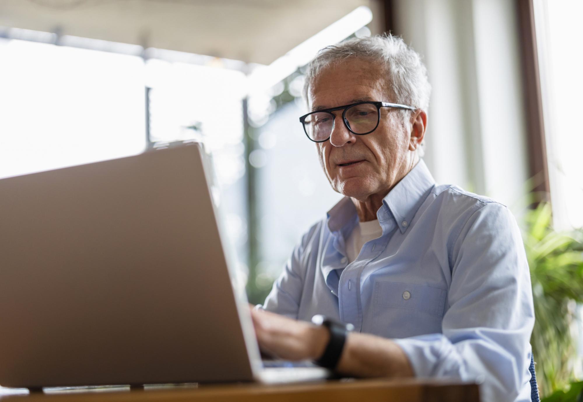 Senior man using laptop