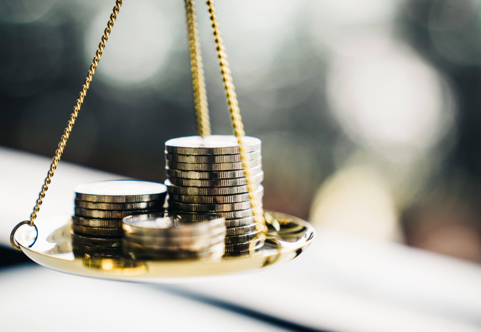 Coins balancing on a scale