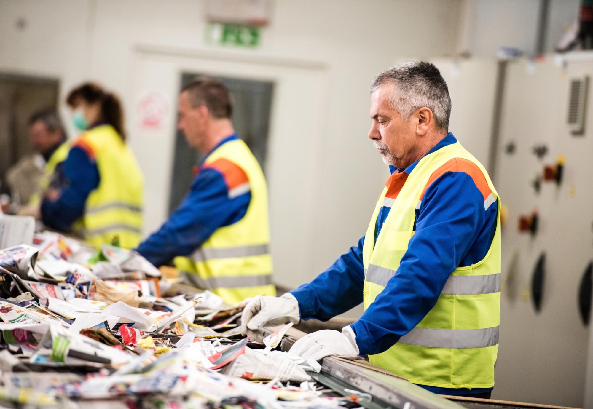 Man working at paper recycling plant