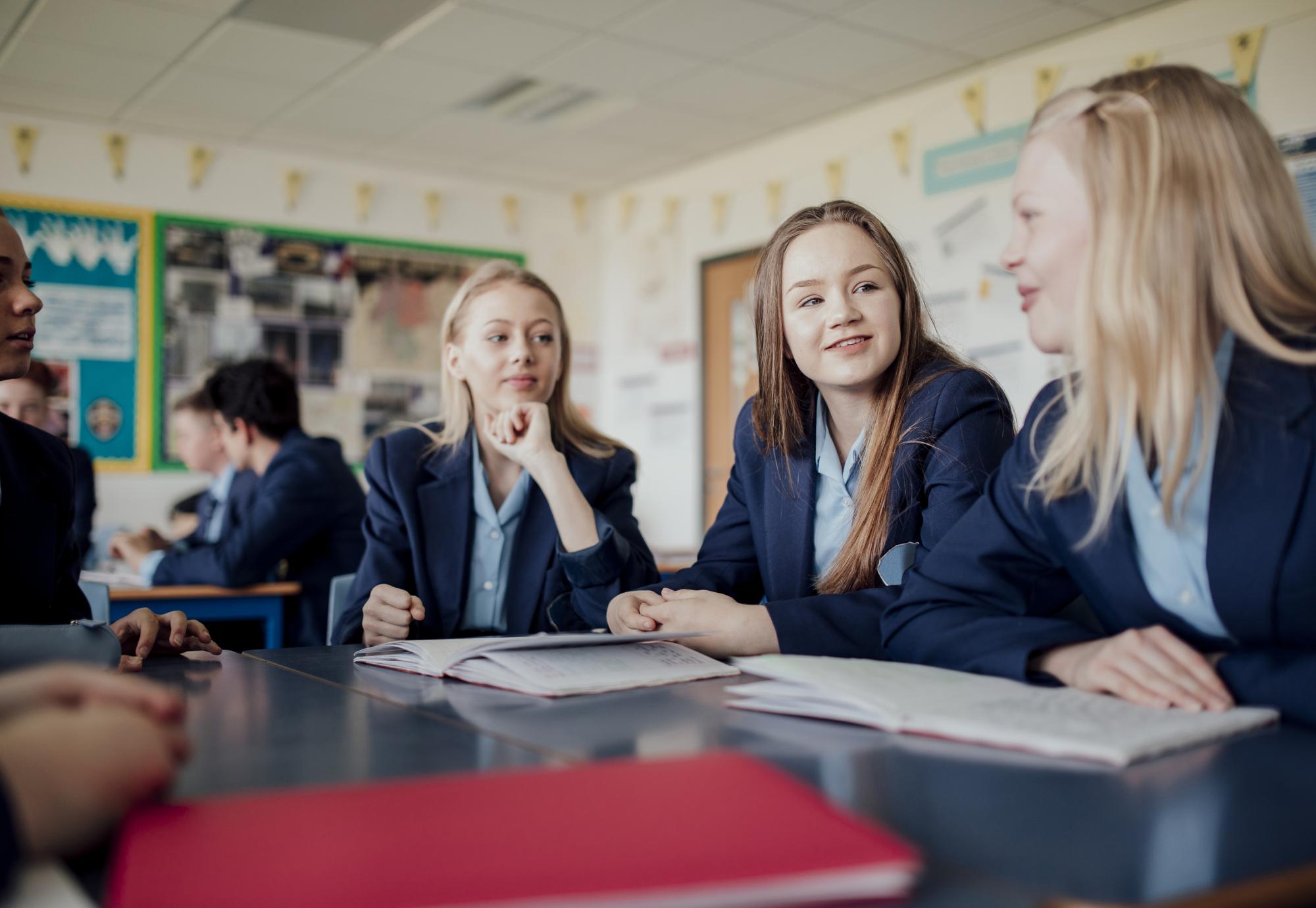 female students talking during a lesson