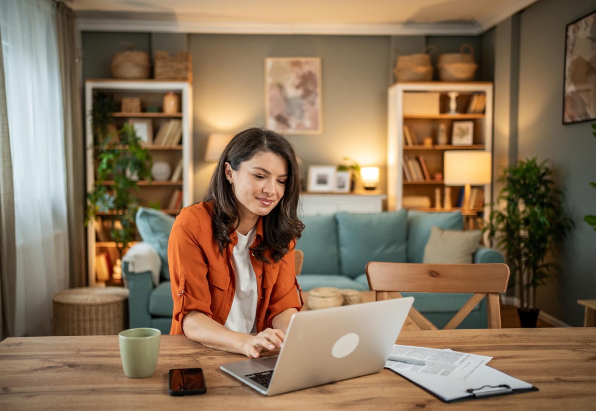 A young woman using a computer at home