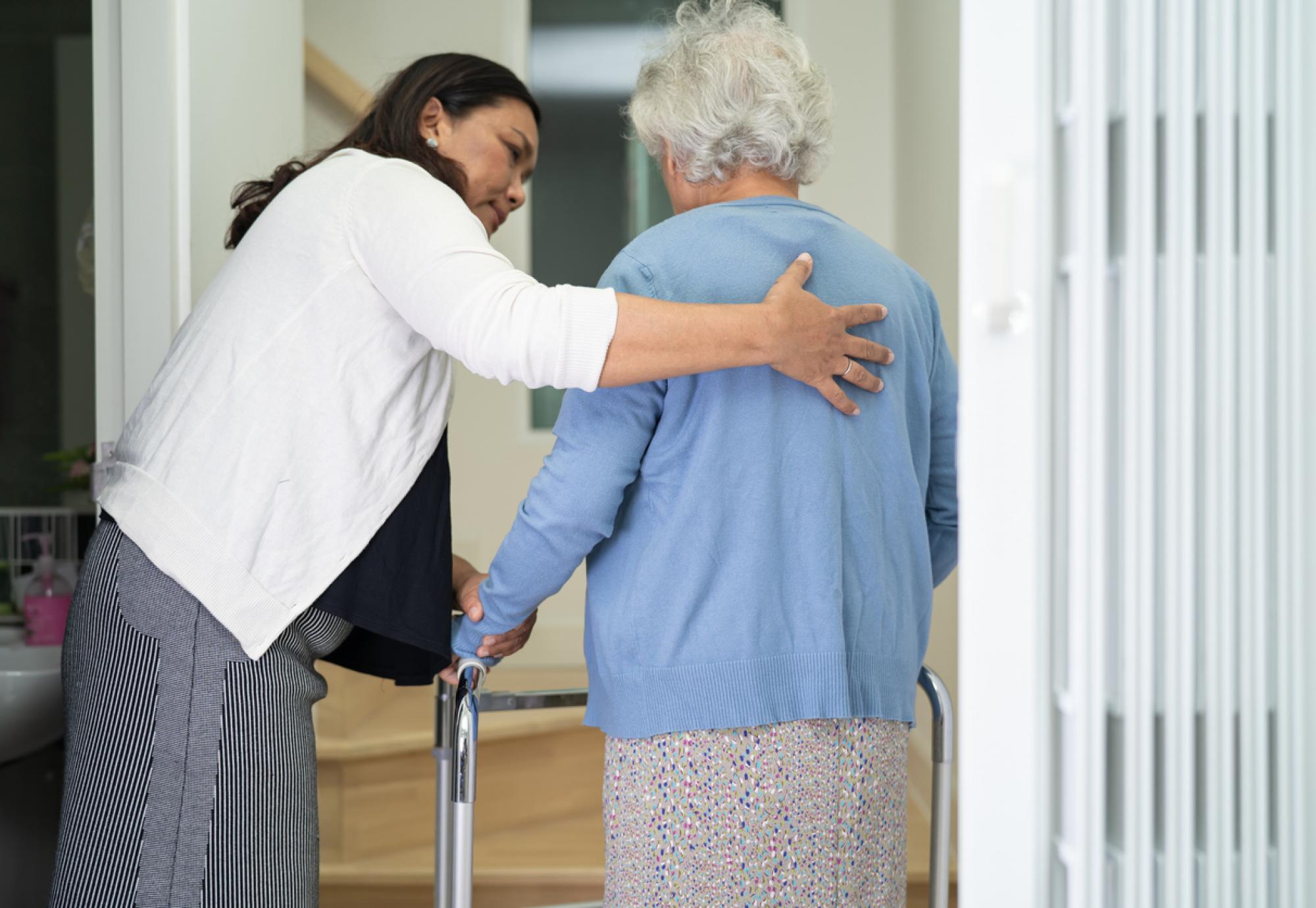 Caregiver helping an elderly woman