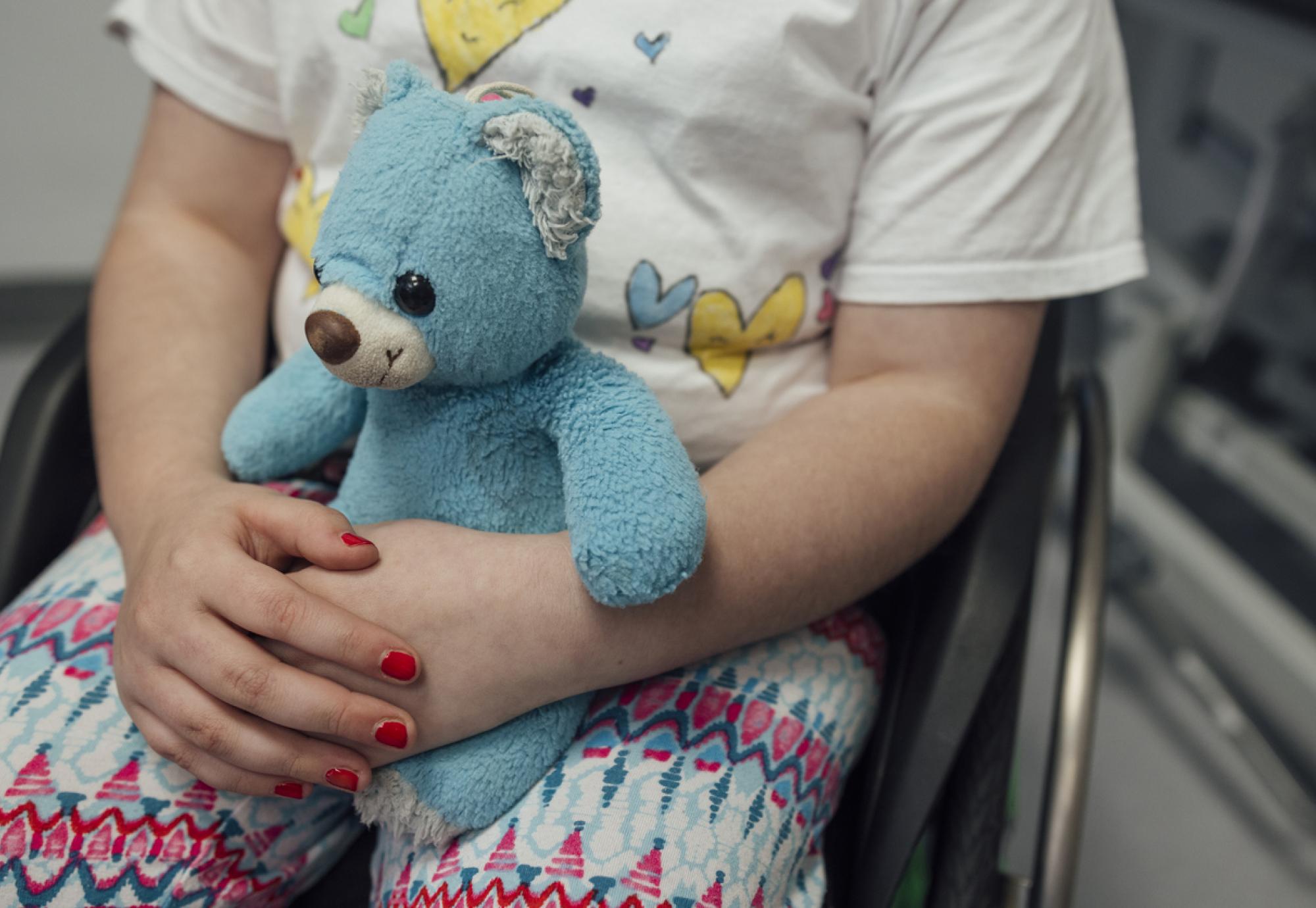 Small child holding a teddy