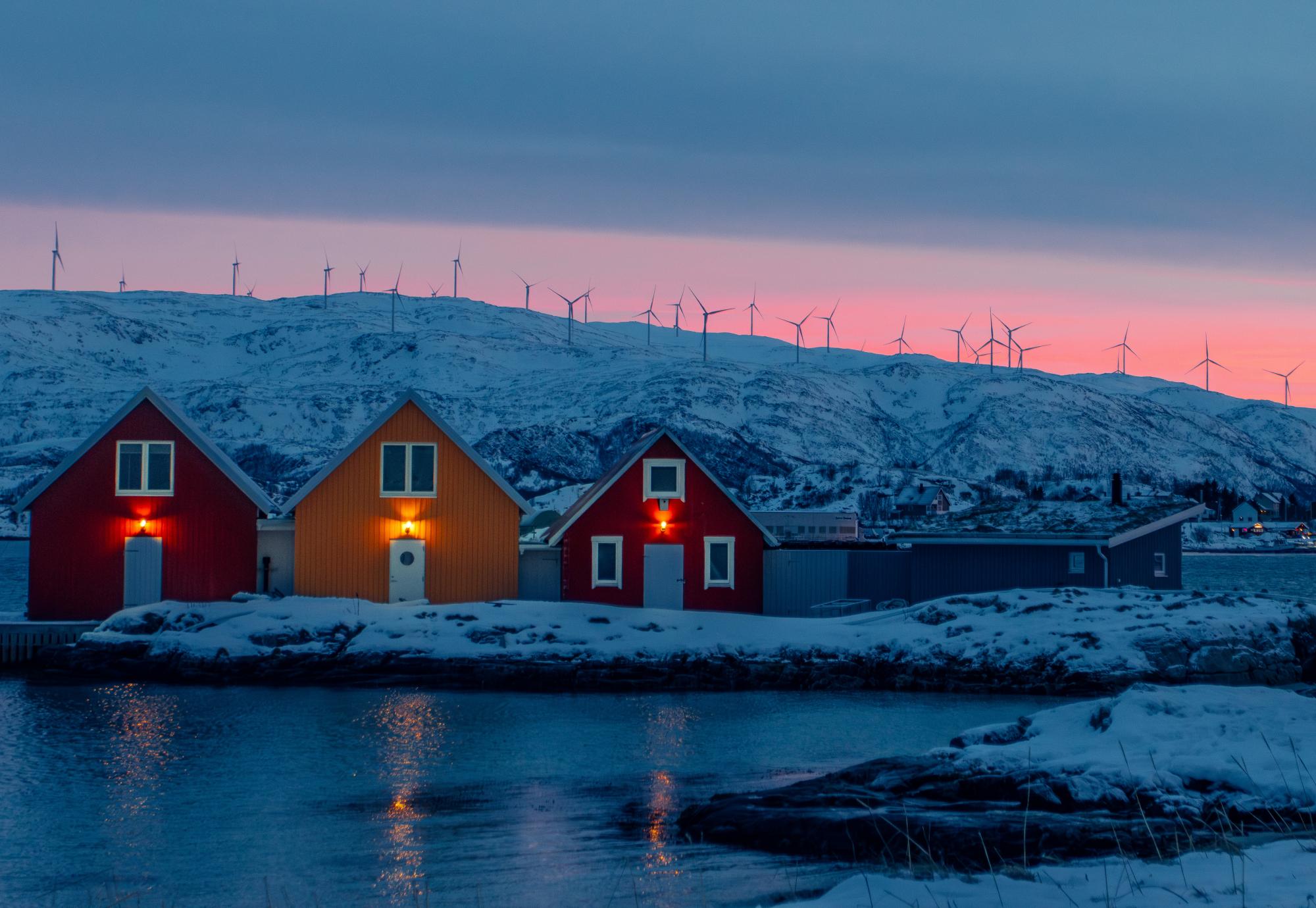 House in Norway with wind turbines behind