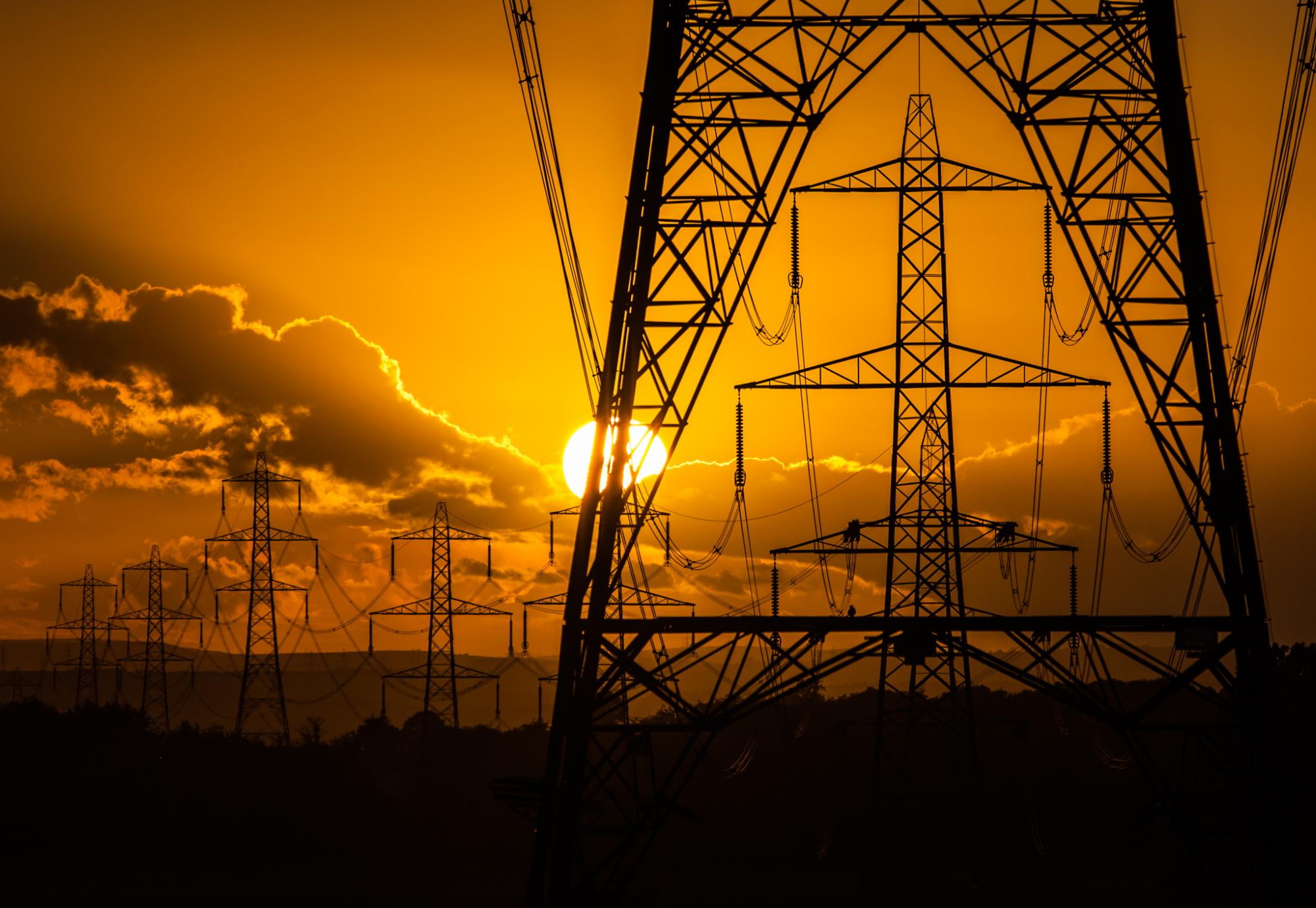 Sunset and silhouette of electricity pylons