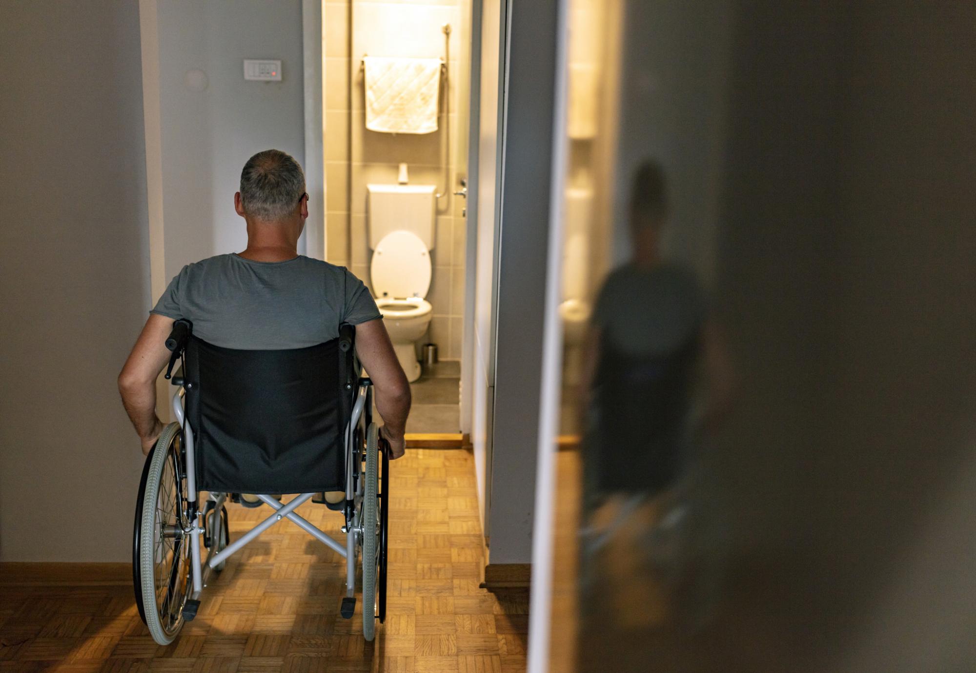 Rear view of mature man on wheelchair