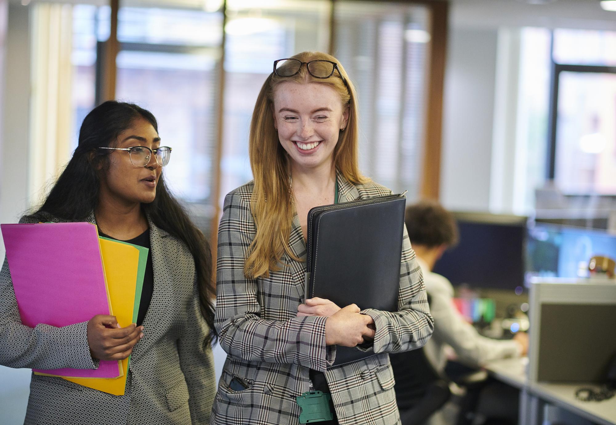 Two interns walking through an office