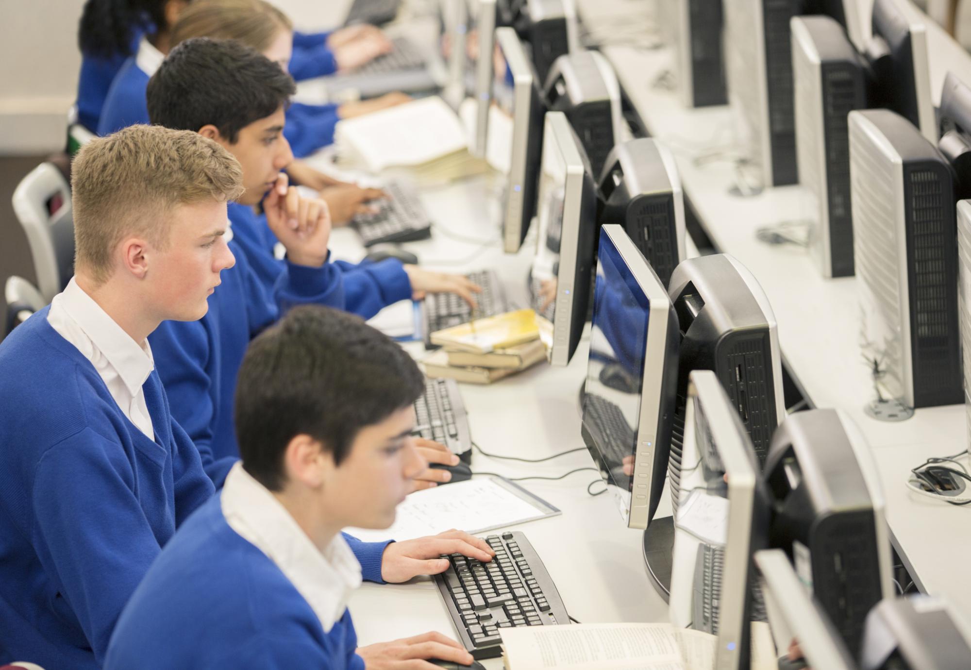 Teenage students using computers