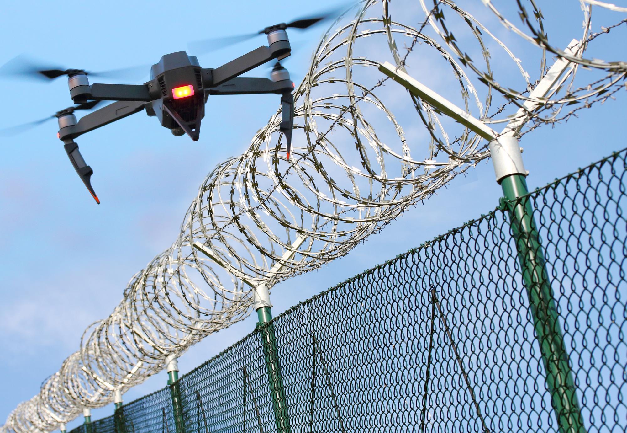 Drone flying over prison fence
