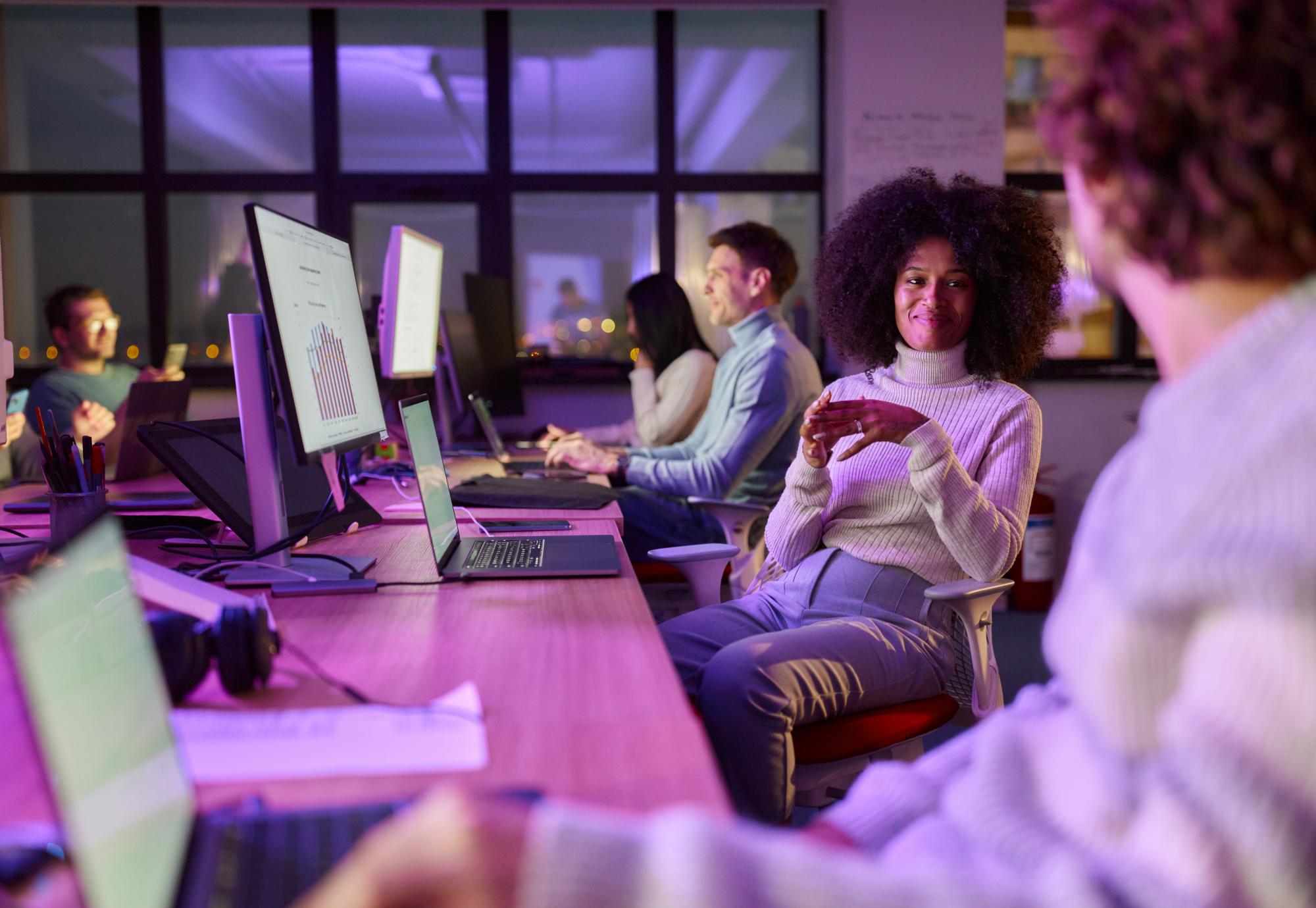 Creative woman talking with colleagues