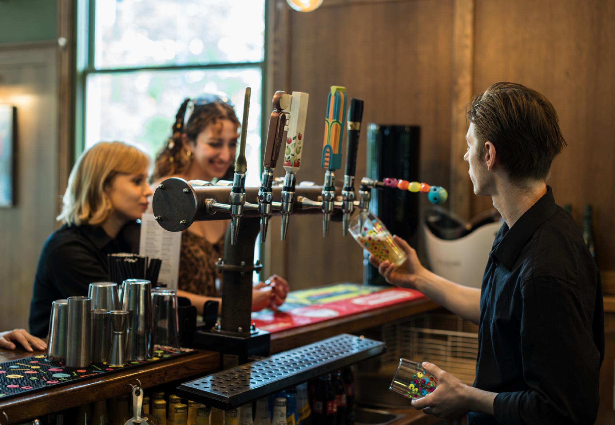 Young man working behind a bar