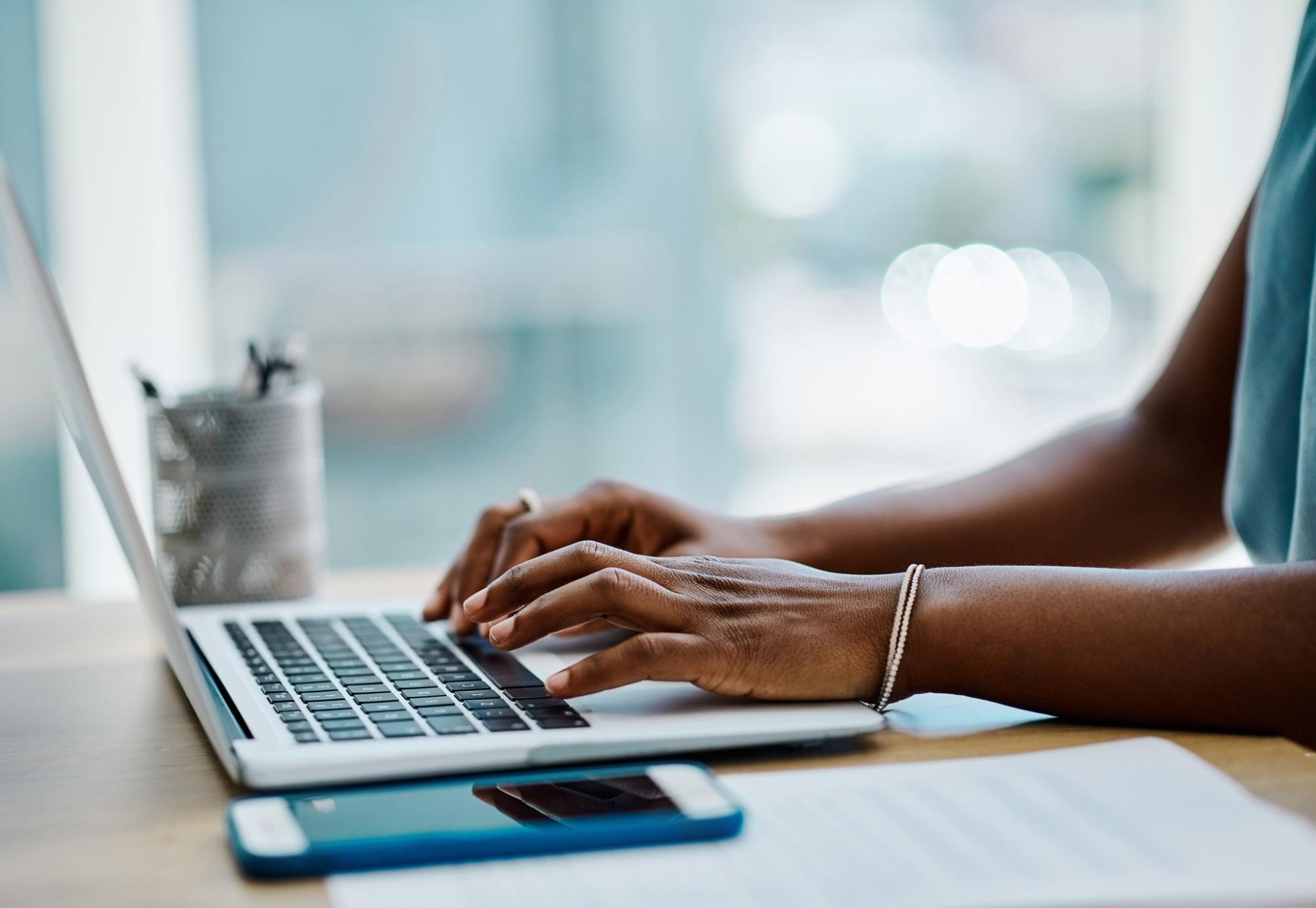 woman typing on a laptop