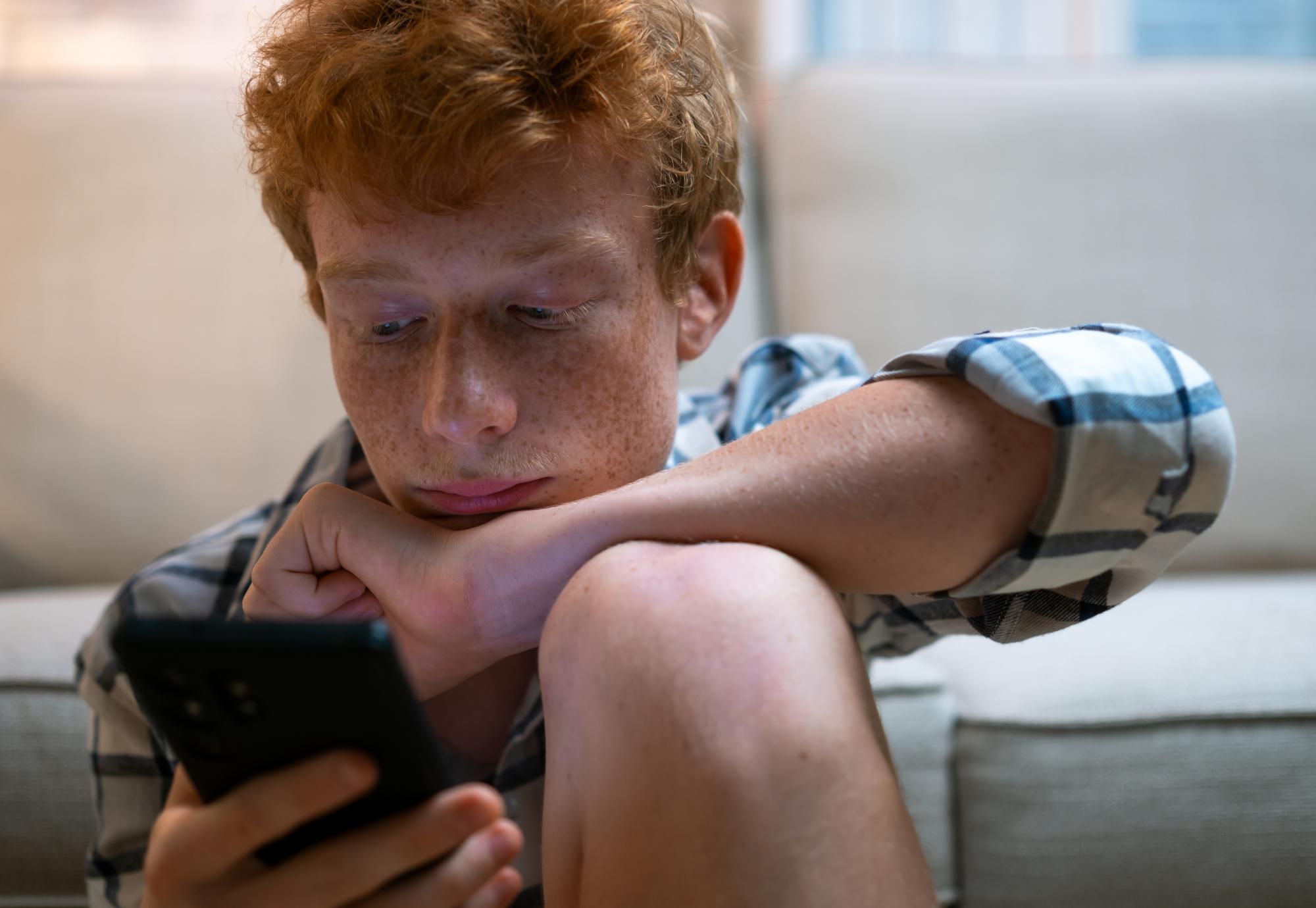 Teenage boy on his phone