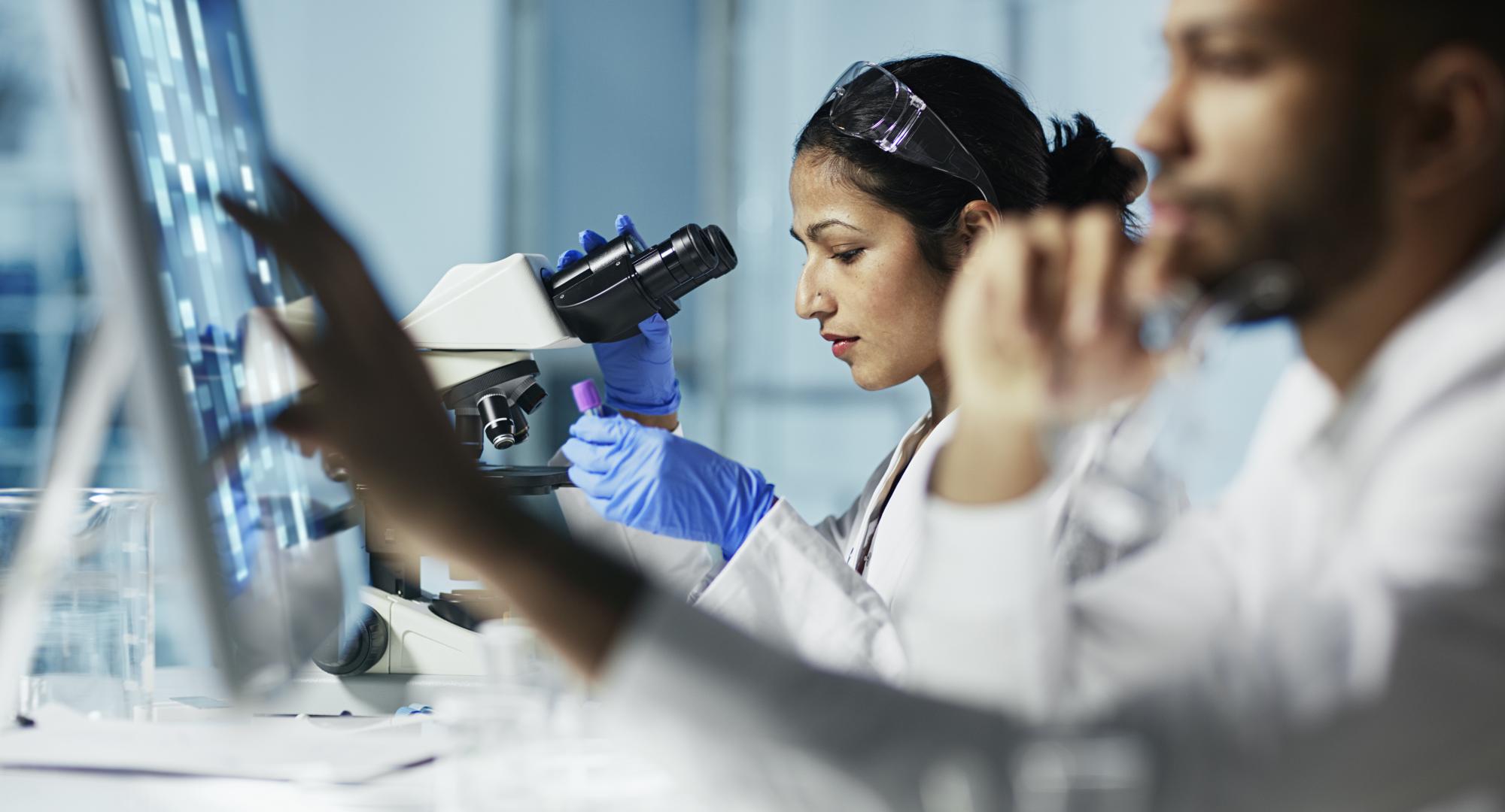 Scientist Working on Computer In Modern Laboratory