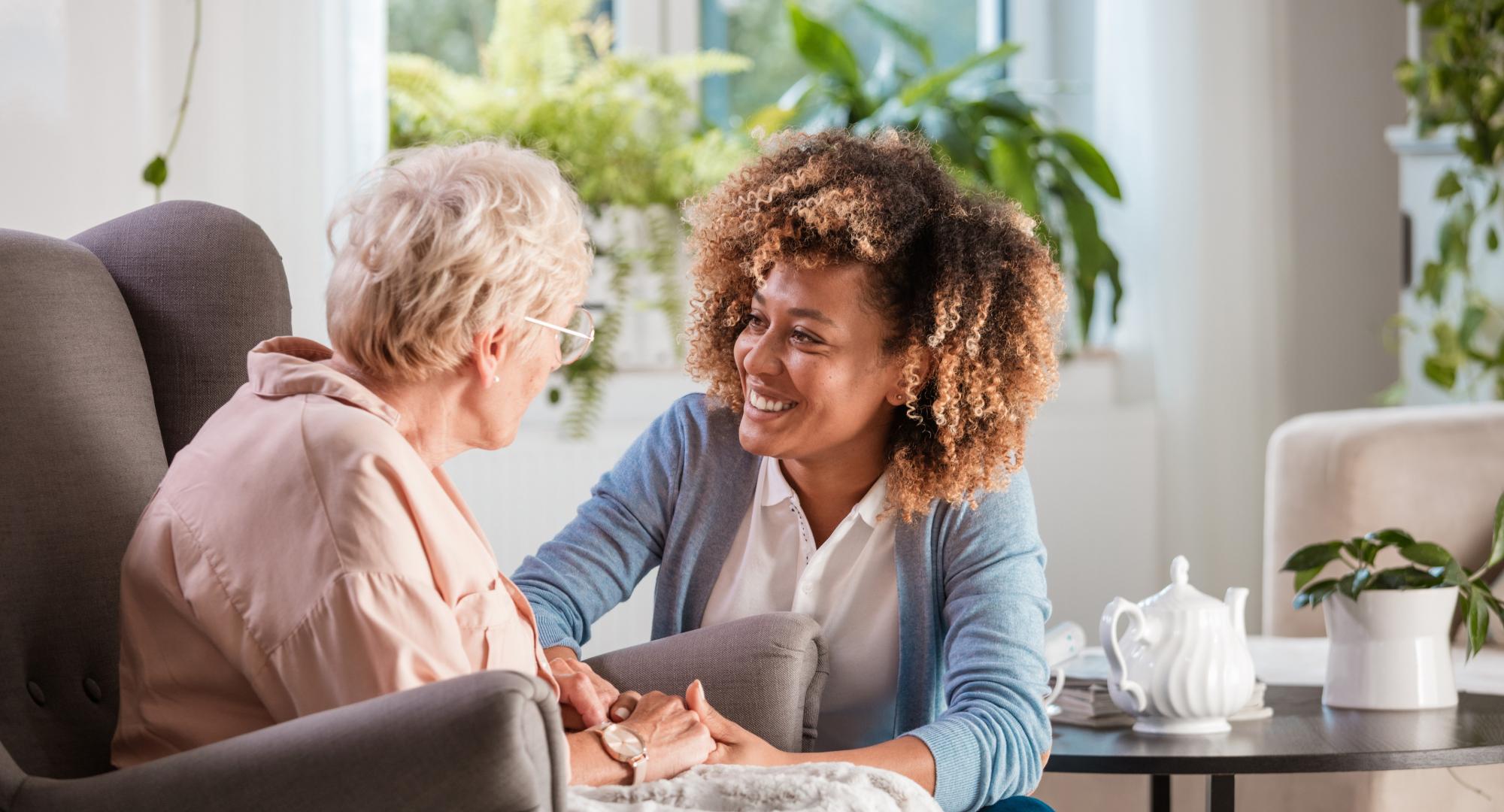 Social care worker helps elderly woman