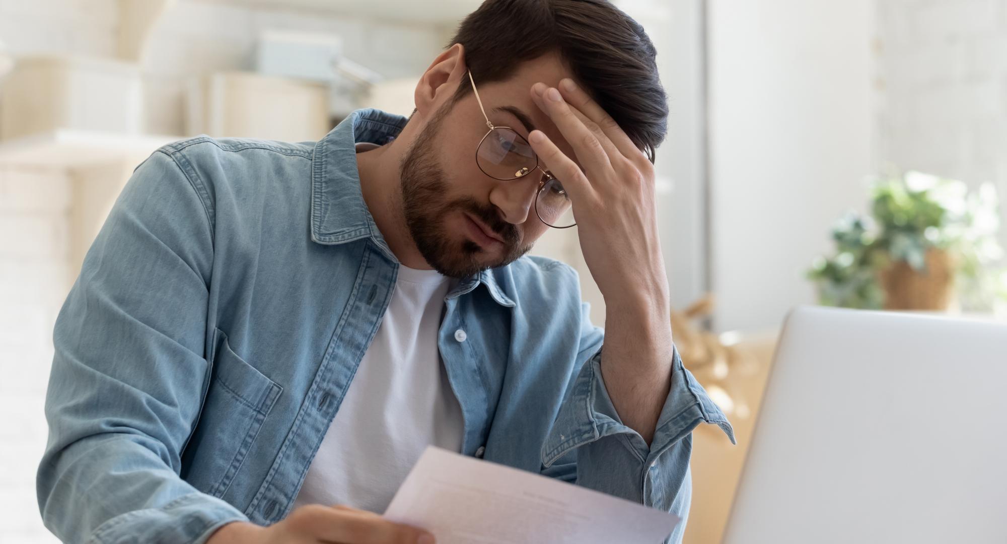 Man looking concerned at rent bill