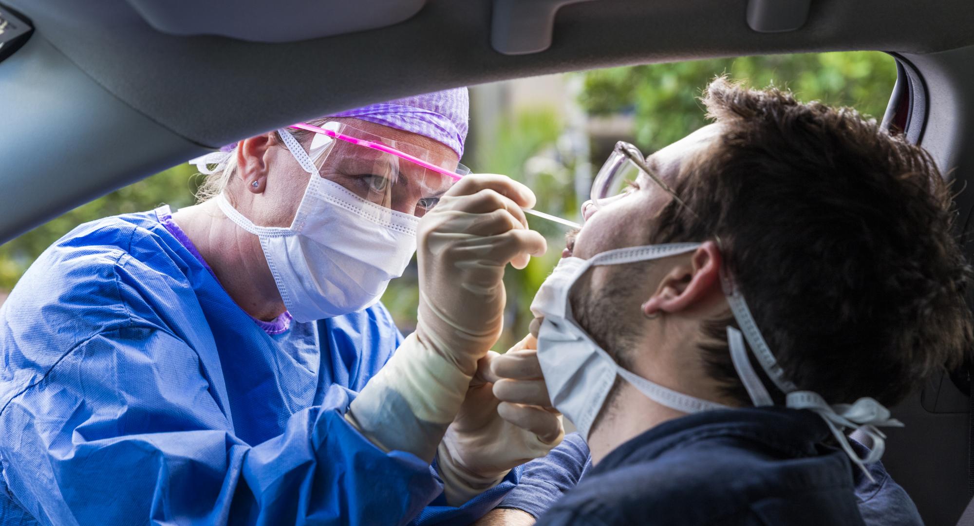 Man getting tested for Covid-19 in his car.