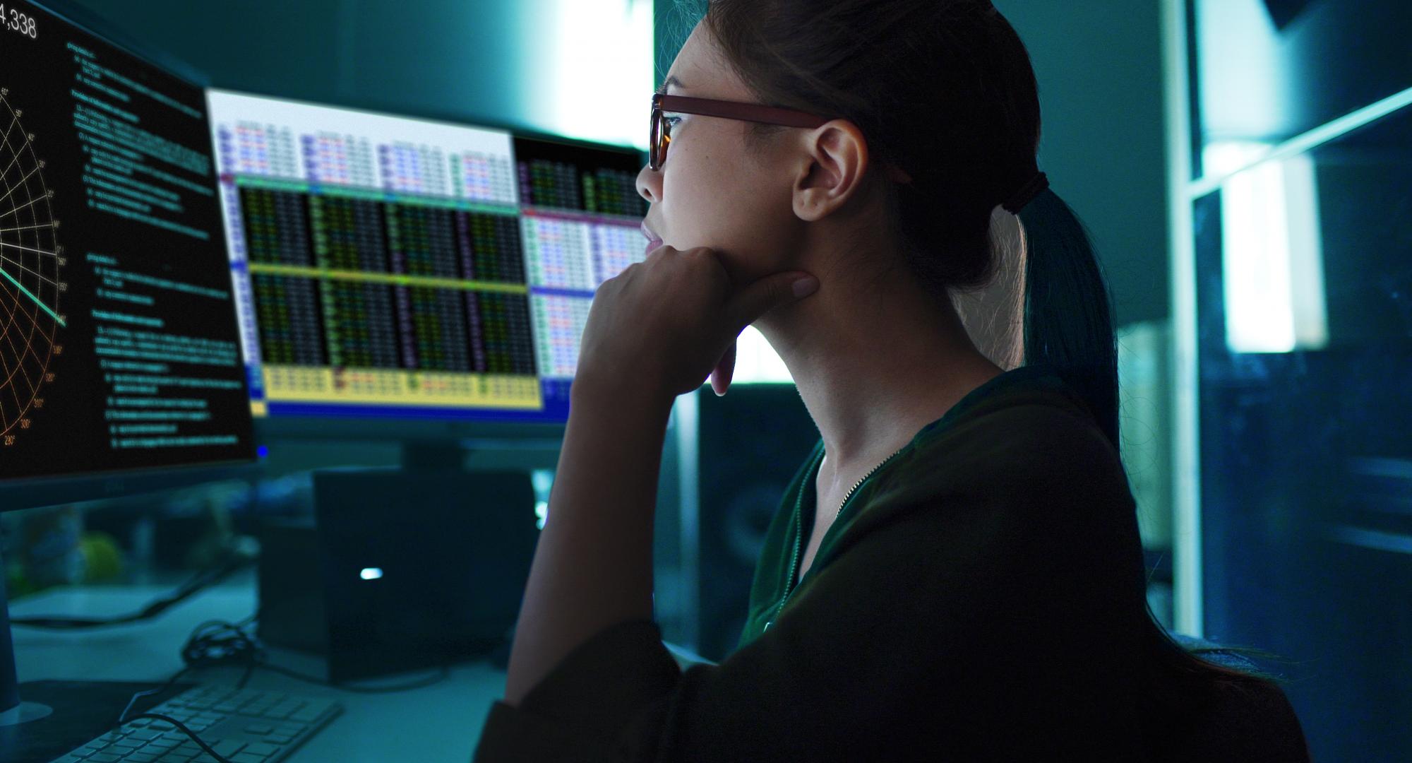 Woman sat at a computer analysing data