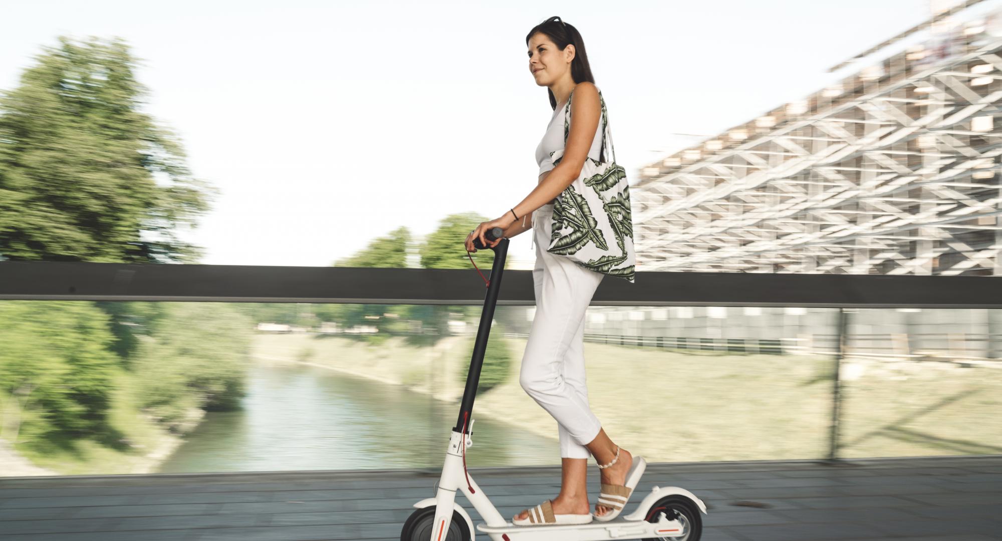 Woman rides an e-scooter