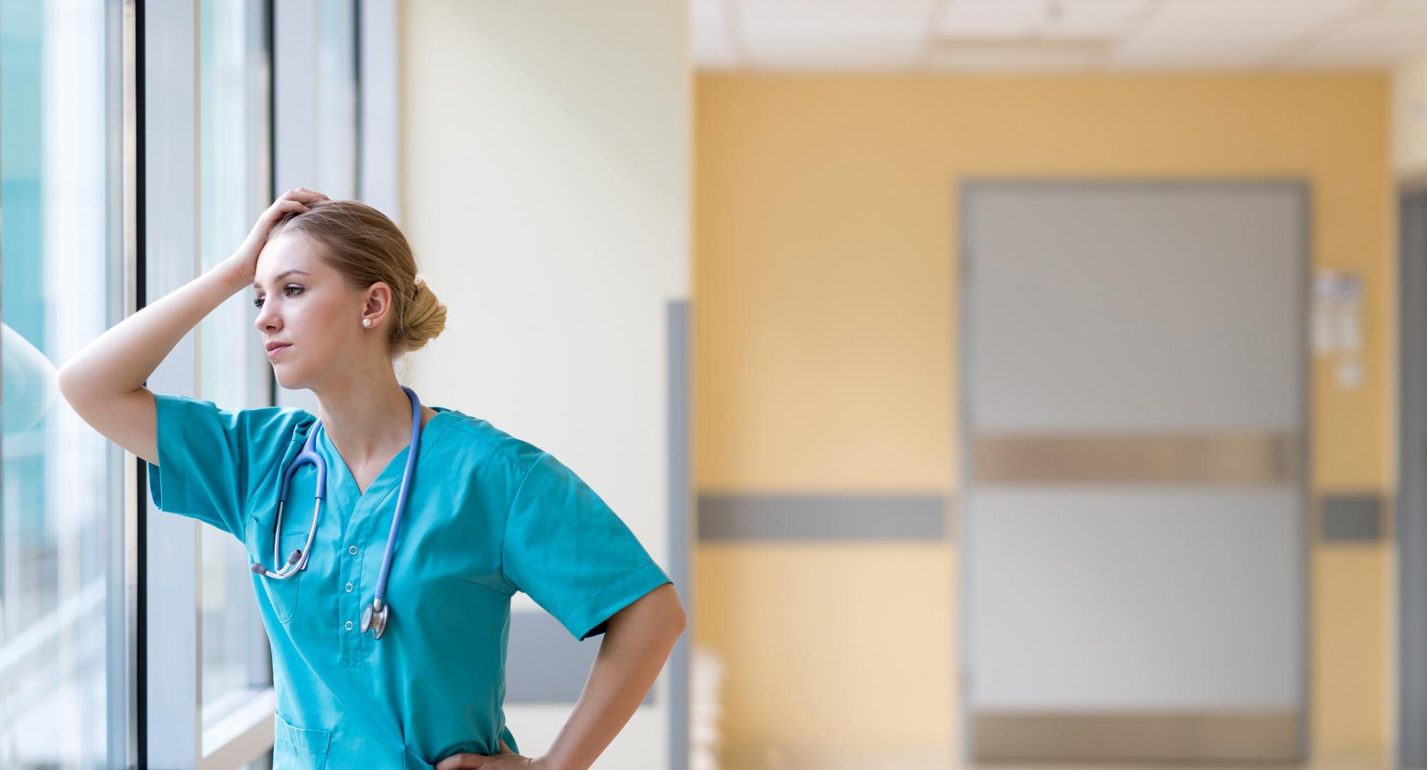 Nurse looking stressed at work
