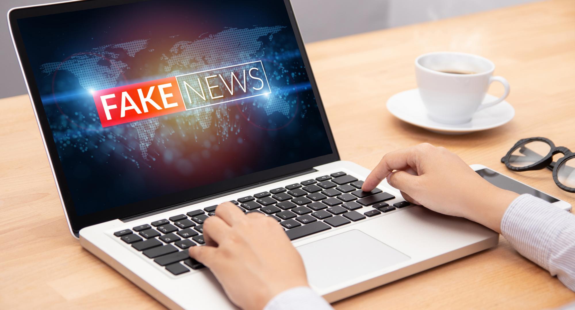 Man looks at fake news on his computer