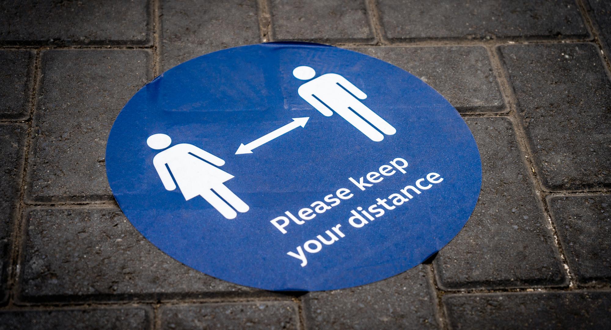 Social distancing sticker on the floor.
