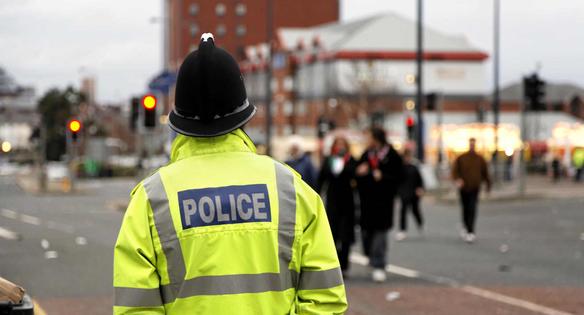 Police man stands guard in the street. 