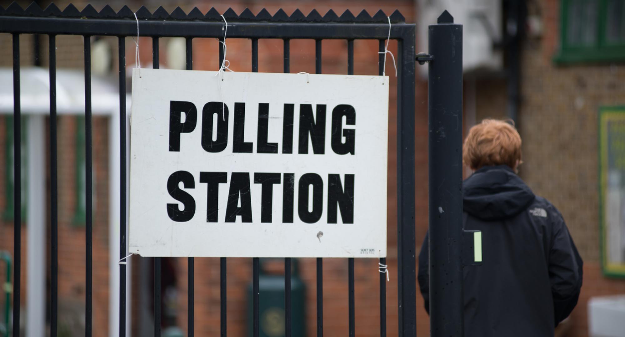 Man walks in to polling station. 