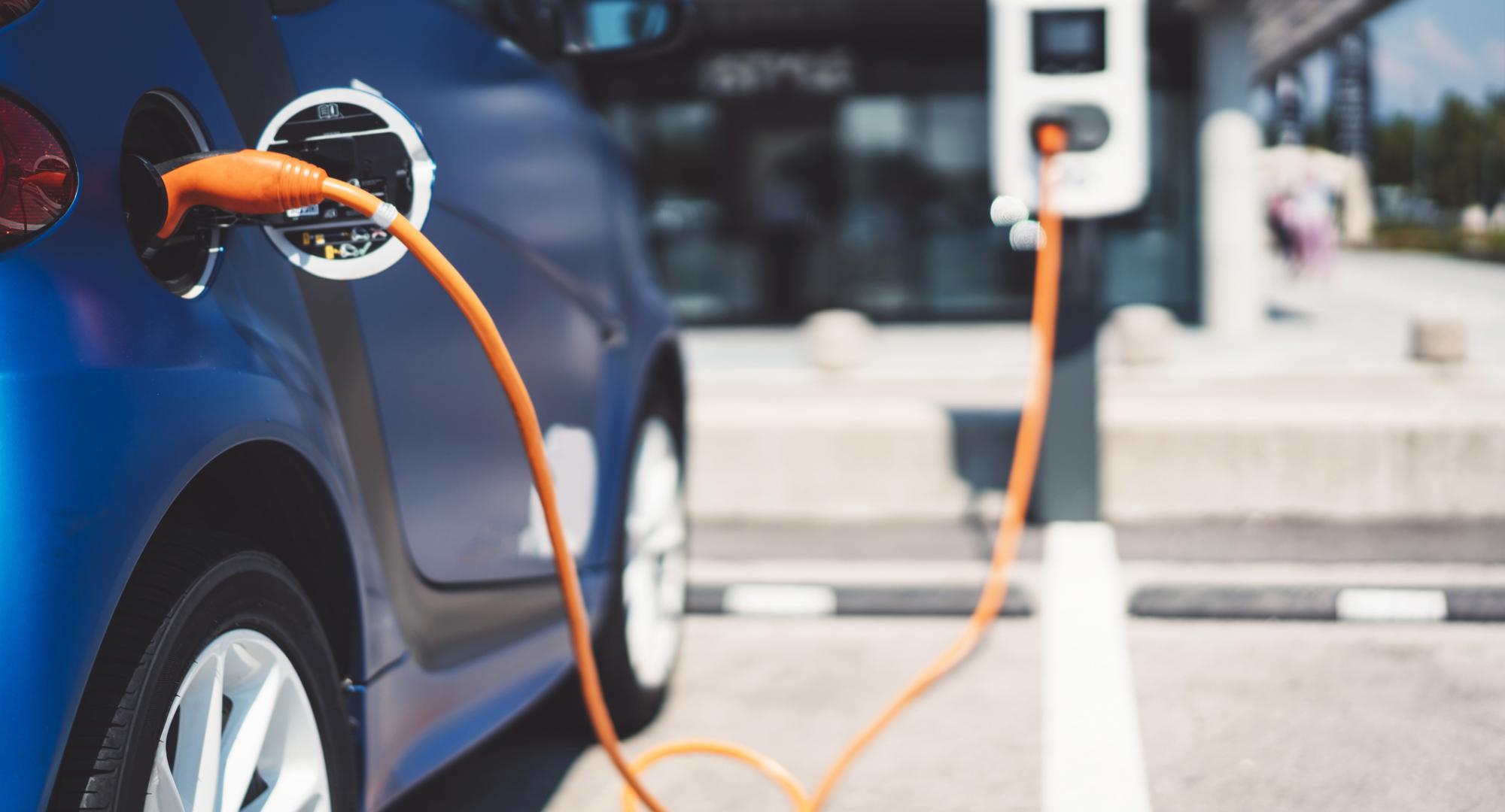 Electric vehicle parked up and charging