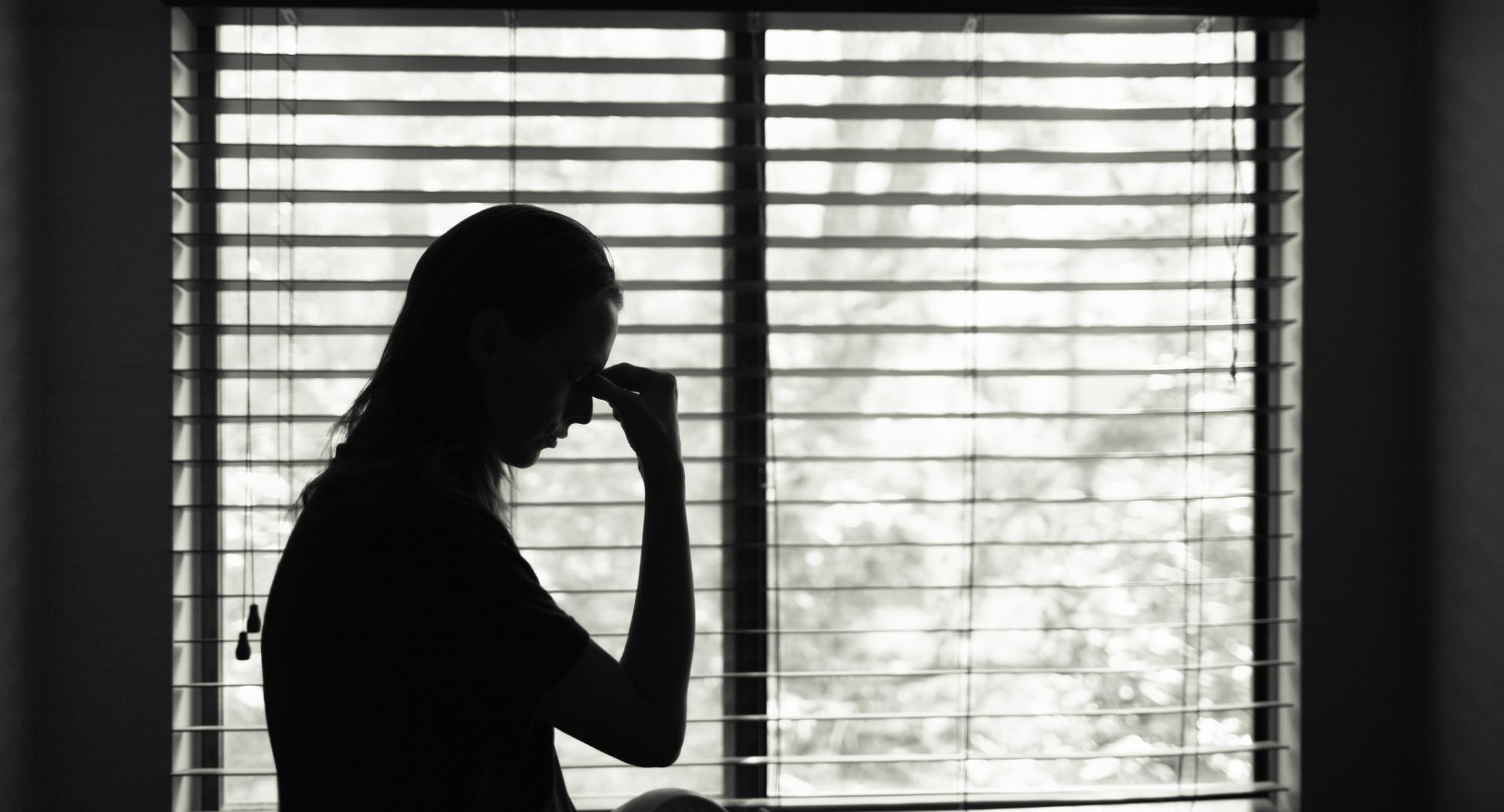 Woman sitting in bedroom